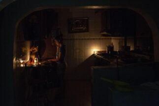 <p>A woman inside her house in Caracas, Venezuela’s capital, during a blackout (Image: Jose Isaac Bula Urrutia / Alamy)</p>