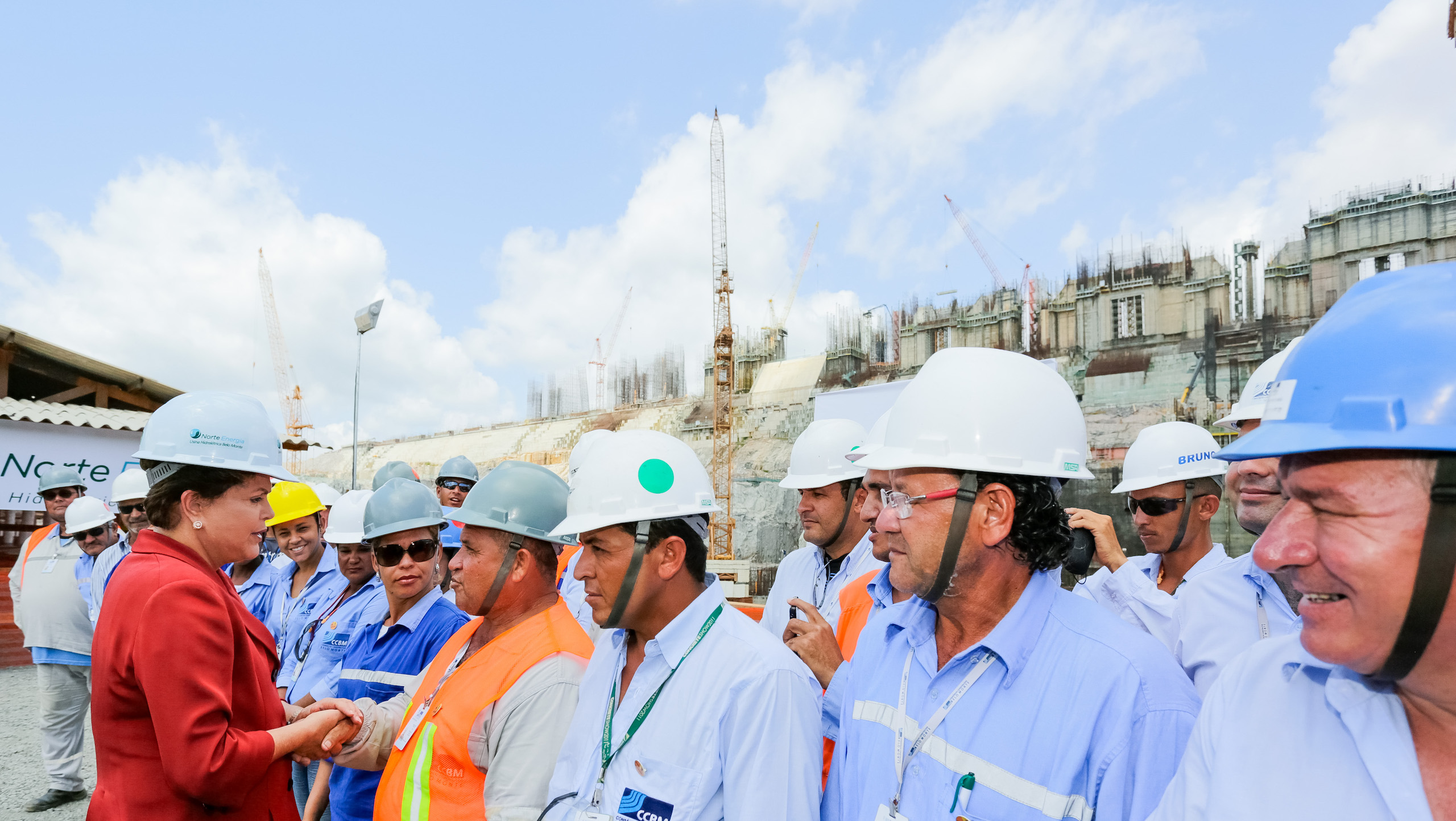 A row of men in hardhats; Former president Dilma Rousseff visited the construction of the Belo Monte hydropower plant 