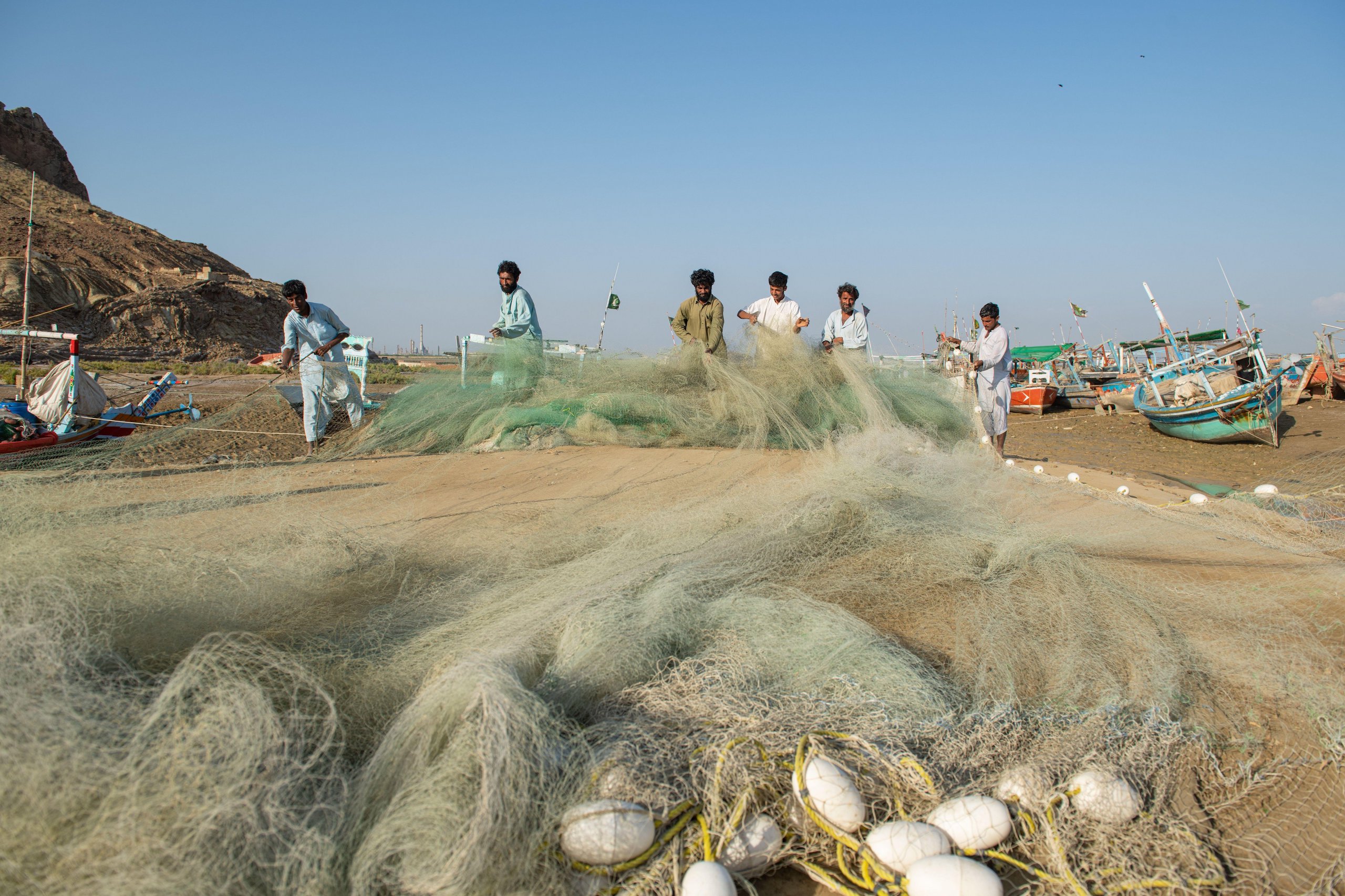 Fishers prepare their nets in Karachi