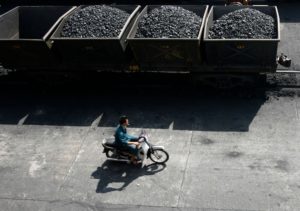 <p>Coal waiting to be loaded onto a Chinese ship at a port in Quang Ninh province owned by a subsidiary of Vietnam’s state-owned mining giant Vinacomin. Re-skilling workers in the coal industry will be an important part of a ‘just transition’ for the country. (Image: Nguyen Huy Kham / Alamy)</p>