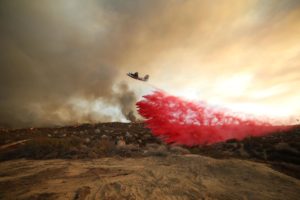 <p>An aircraft drops flame retardant on a wildfire near Hemet, California in September 2022 (Image: David Swanson / Alamy)</p>