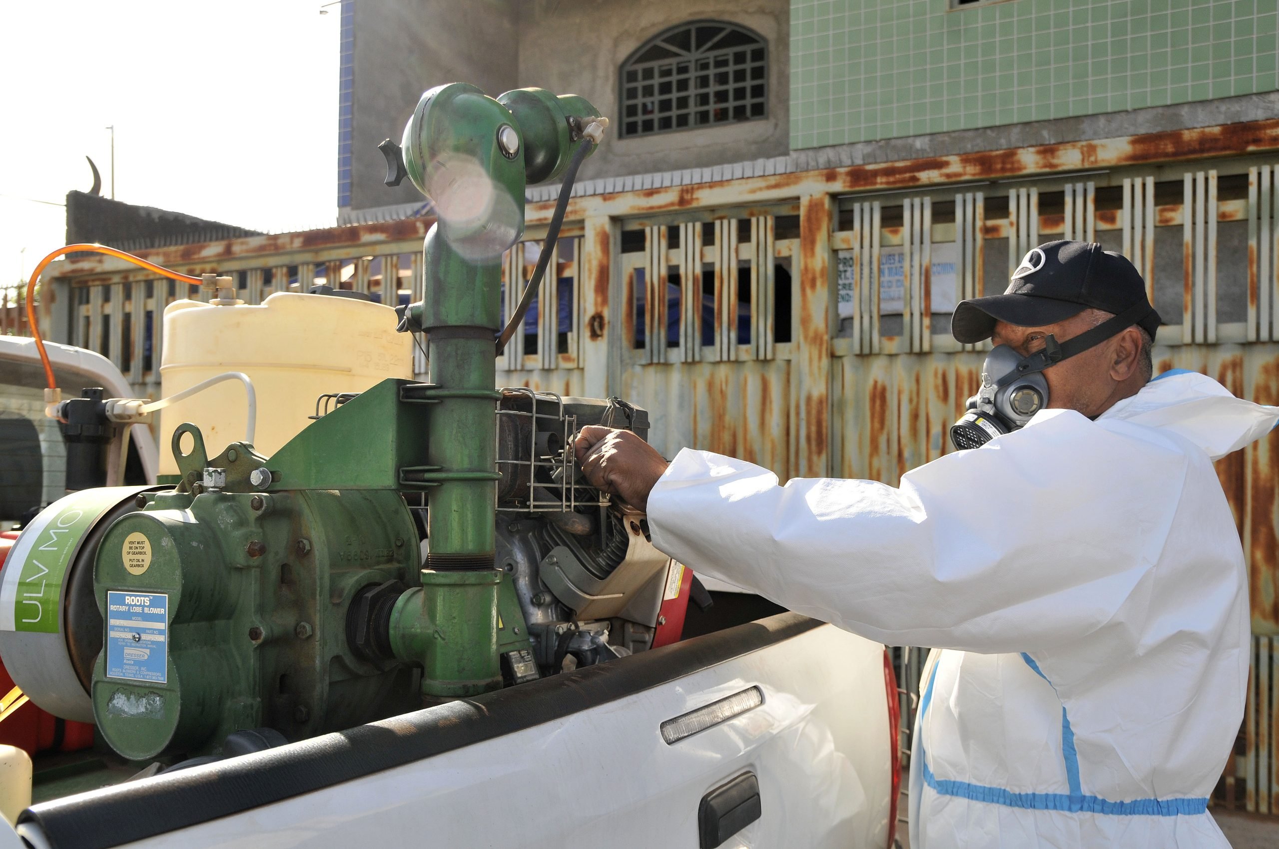 A man uses a machine to spray insecticide in Brasilia, Brazil, to counter the threat of mosquitoes
