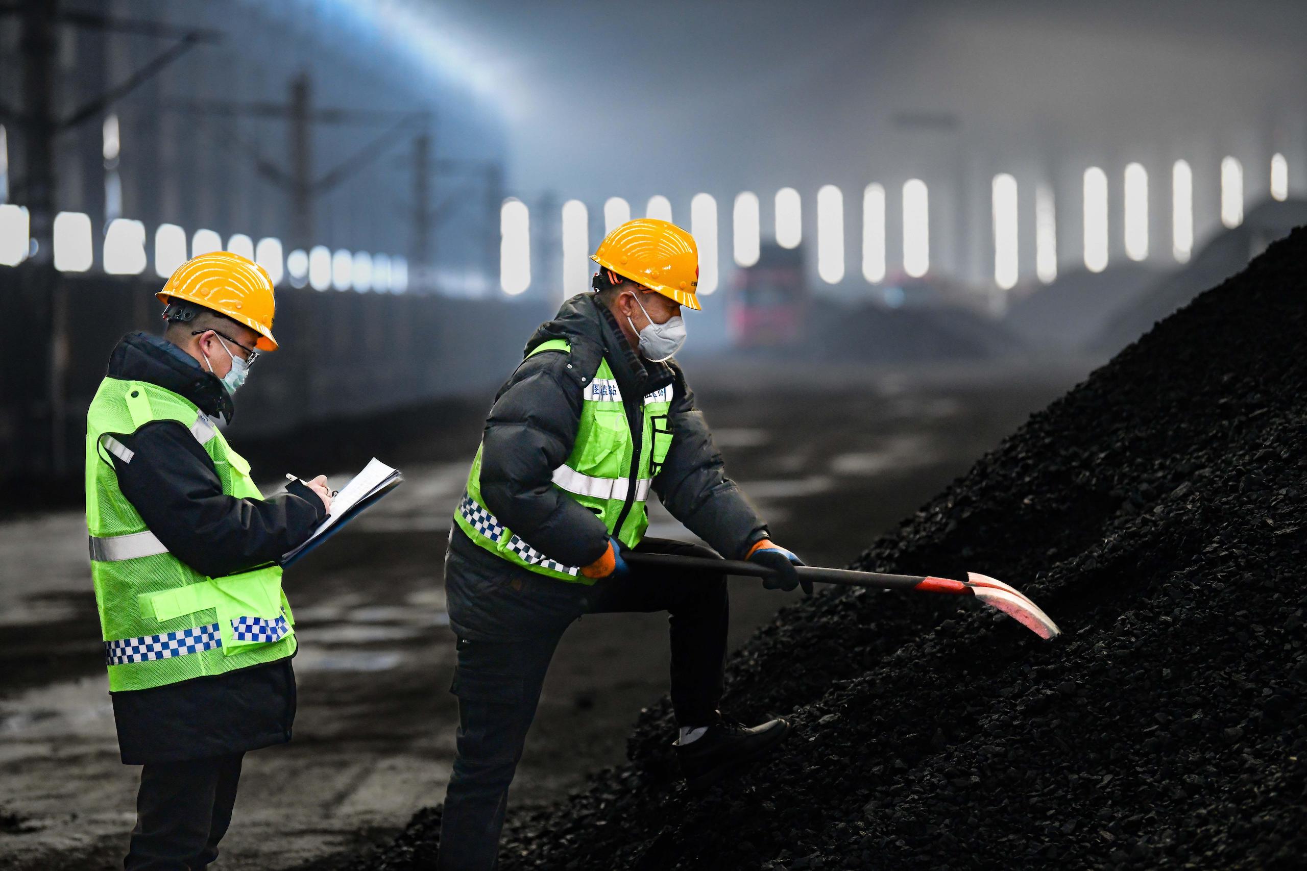 Workers checking coal quality at the Buertai coal mine in Inner Mogonlia