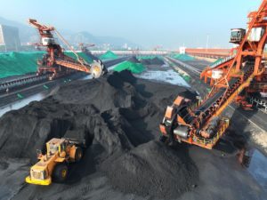 A bucket turbine piles coal unloaded by a cargo ship for storage at a coal yard in Lianyungang City, Jiangsu