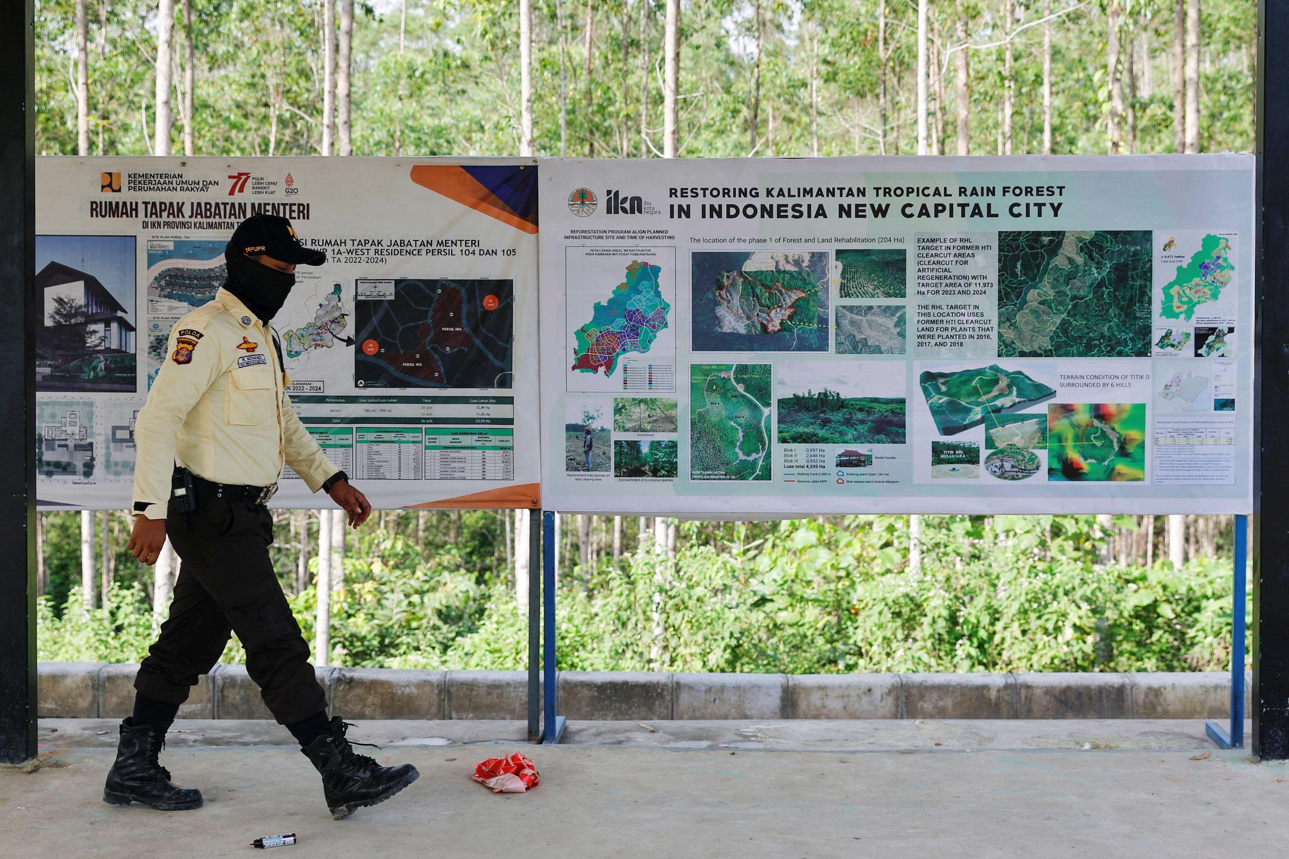 A security guard walks past information boards at the ground zero of Indonesia's new capital, known as Nusantara 