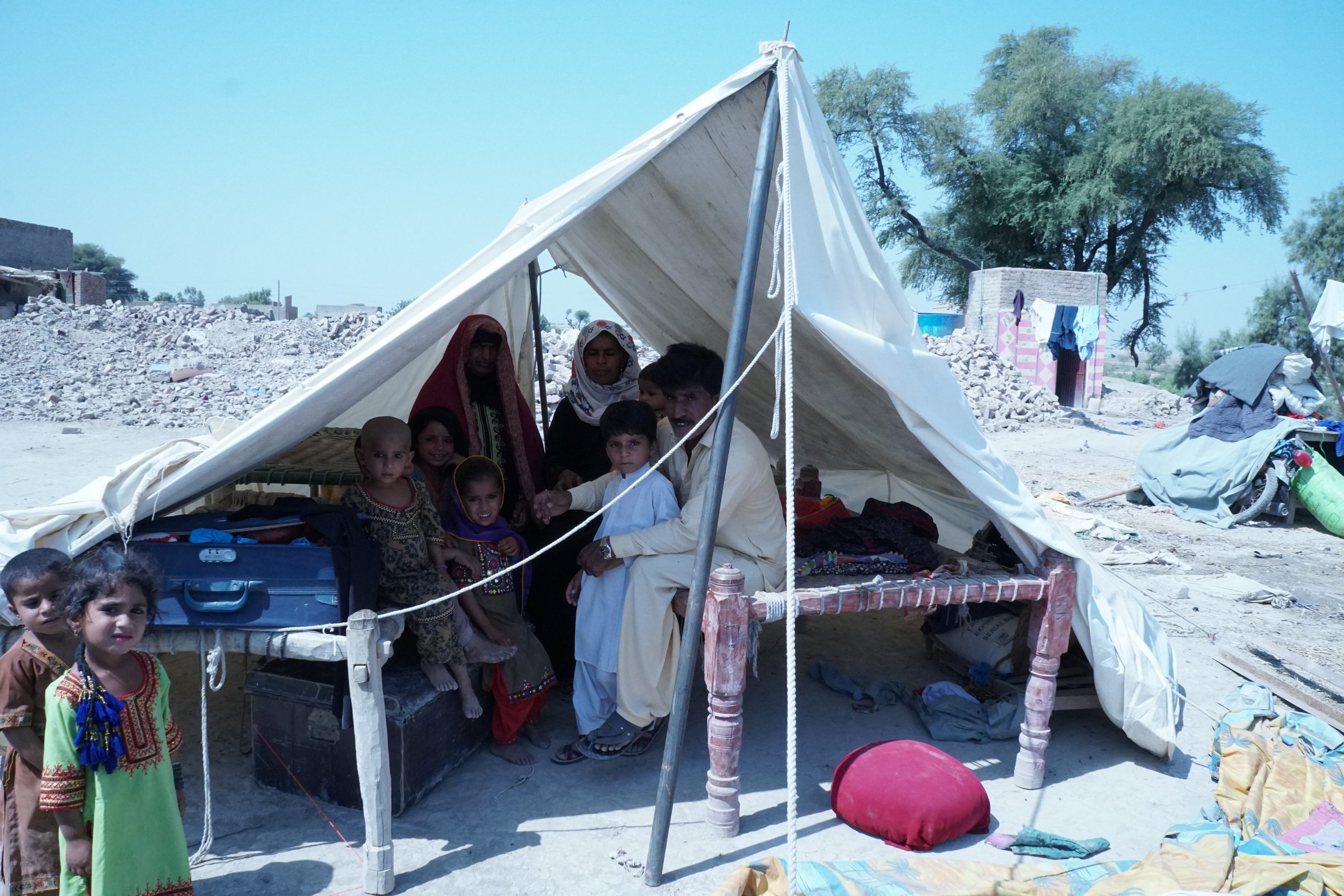 family sitting under triangular tent