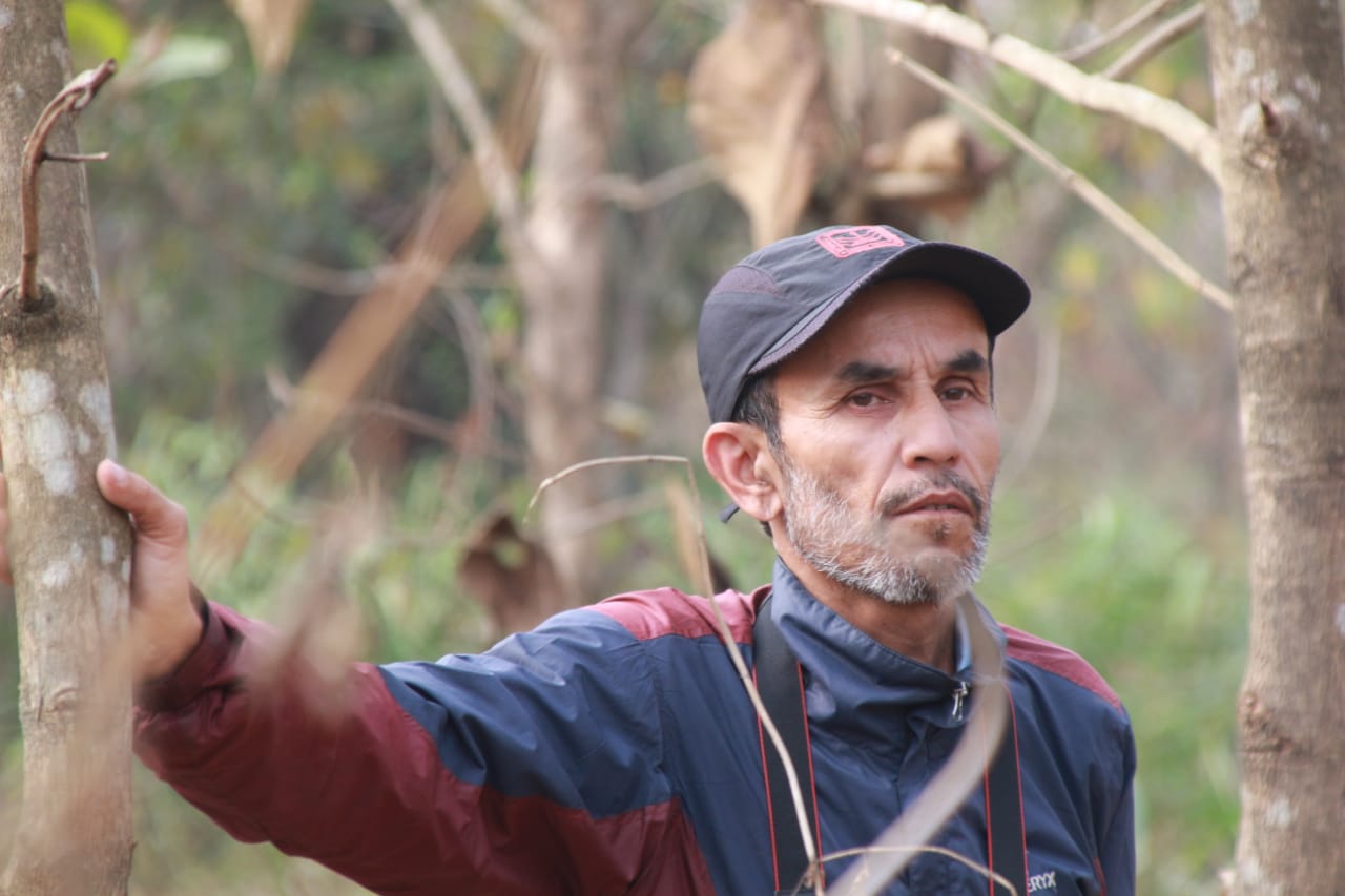 portrait of man standing in woods