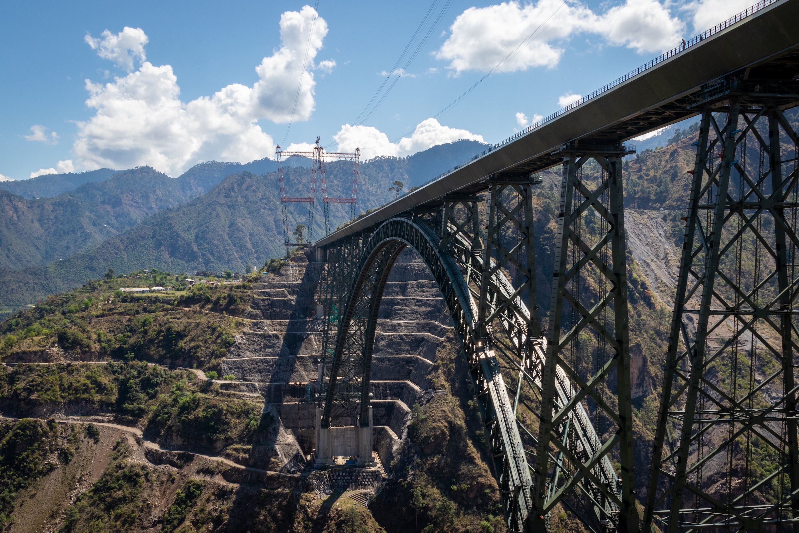 Overview of Chenab Rail Bridge visibly showing the hill and road cutting in between Bakkal and Kauri villages of Reasi district in Jammu and Kashmir. (Image : Ashish Kumar Kataria)