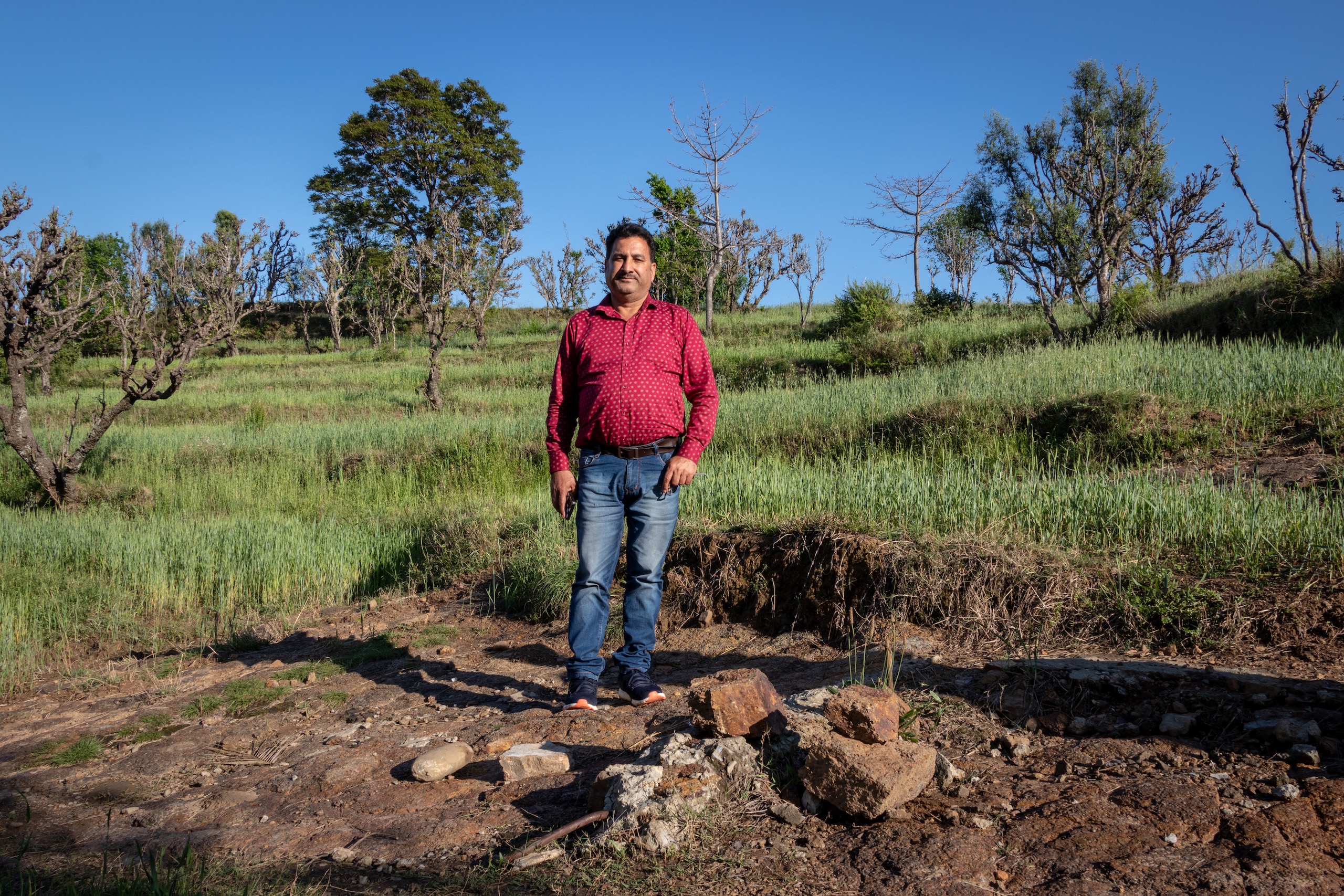 Pritam Singh, 55, village head of Salal, stands over the point where for the first time lithium testing was conducted by the Geological Survey of India at Salal-Haimana in Reasi district of Jammu and Kashmir. The presence of lithium reserves at Salal was already mapped in 1999. (Image : Ashish Kumar Kataria) 