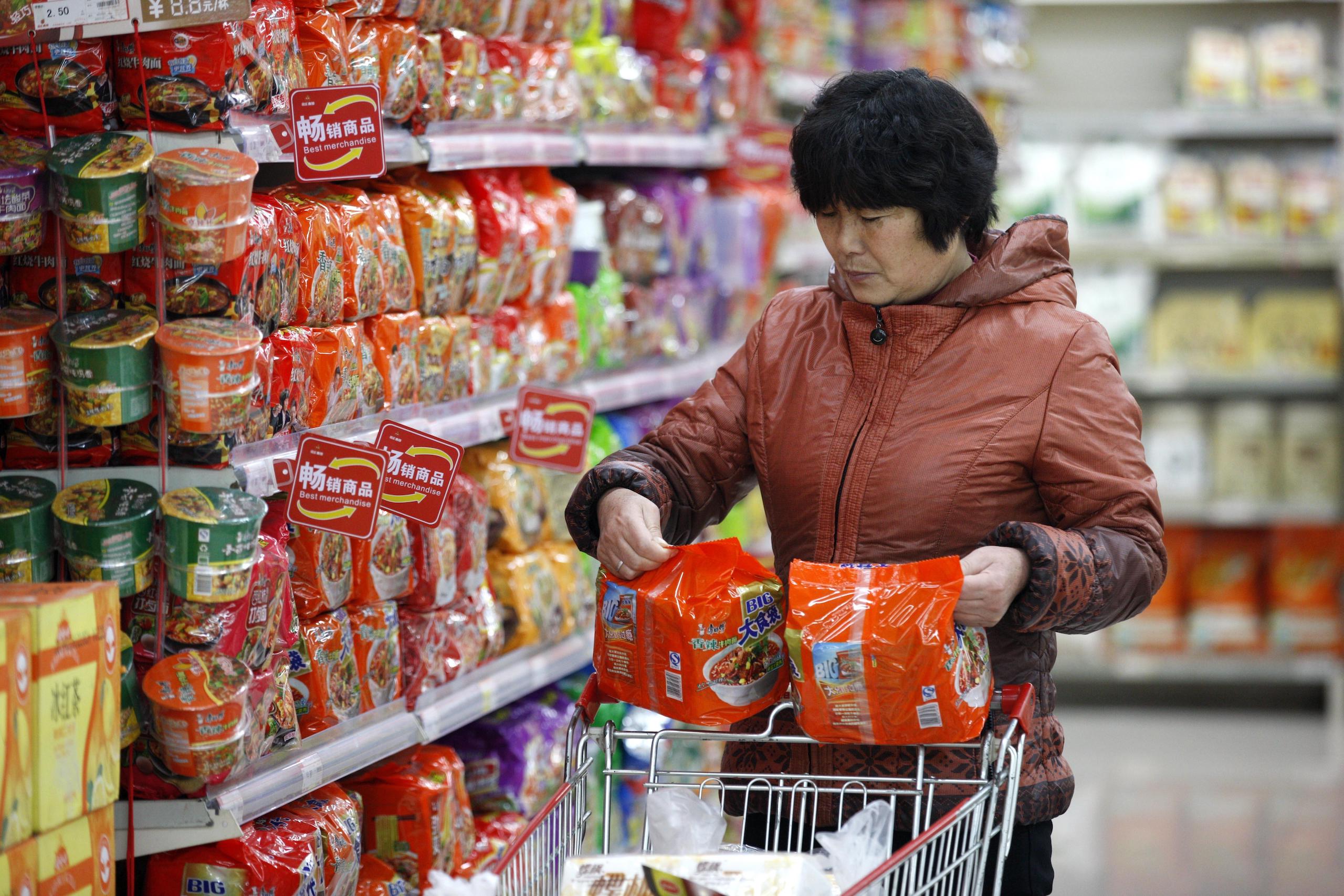 A customer buys instant noodle at a supermarket