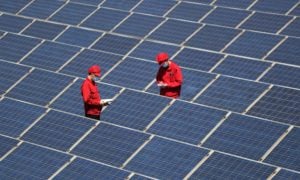 <p>Technicians inspect a rooftop solar system in Qingdao, Shandong (Image: Cynthia Lee / Alamy)</p>