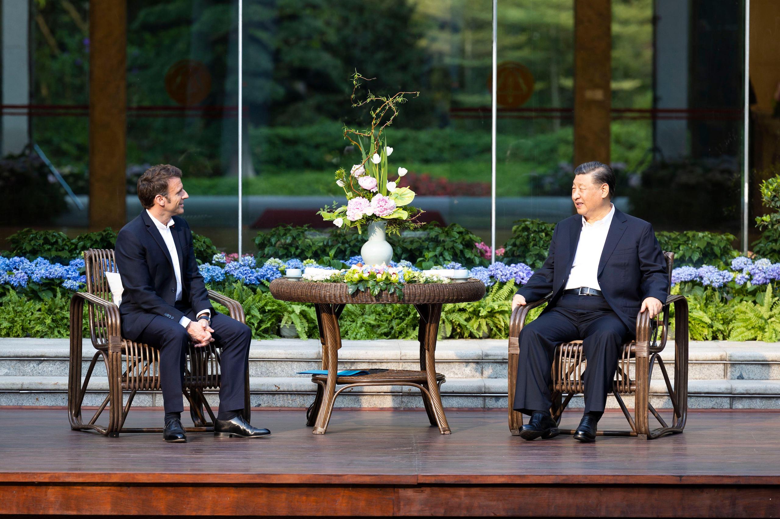 Chinese President Xi Jinping and French President Emmanuel Macron have tea at a garden in Guangzhou, China