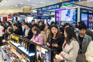 Crowds of customers shop for cosmetics and skincare products at a shopping mall in Chengdu