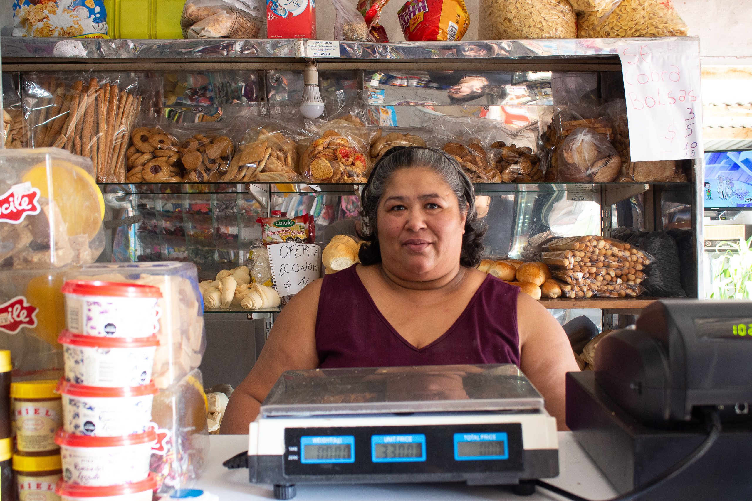 woman behind counter in small shop