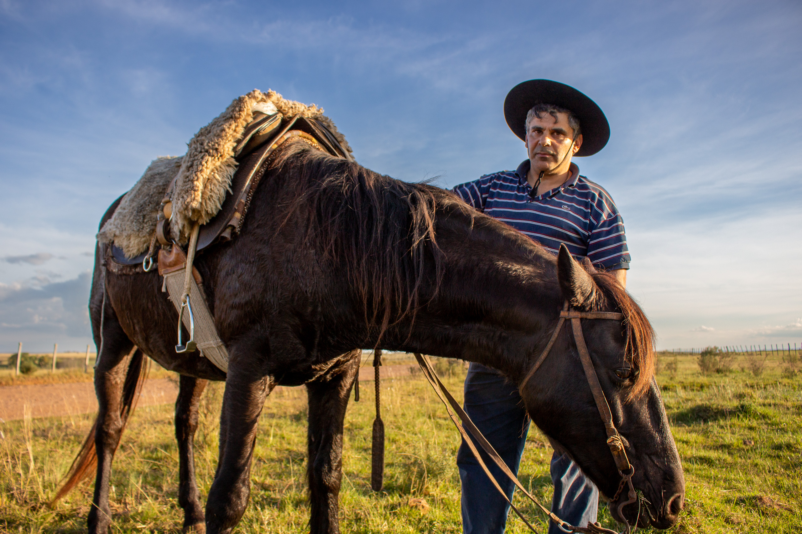 man standing near horse