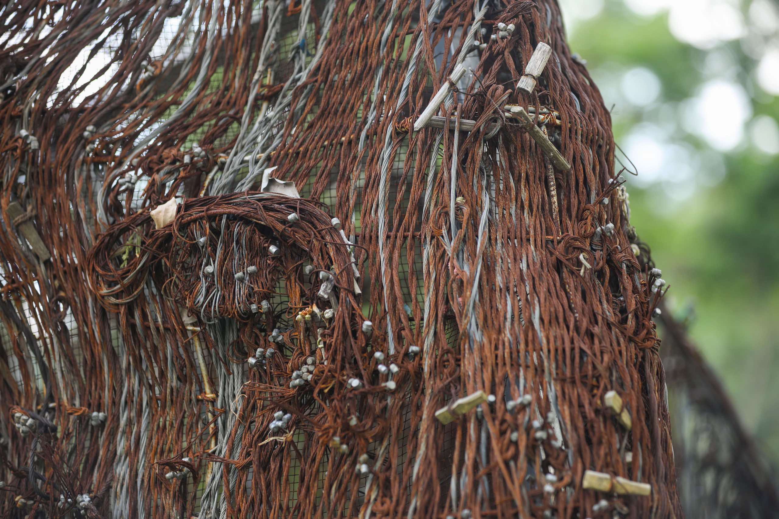 A sculpture of an Asian elephant herd made of snares and other wildlife traps, close up