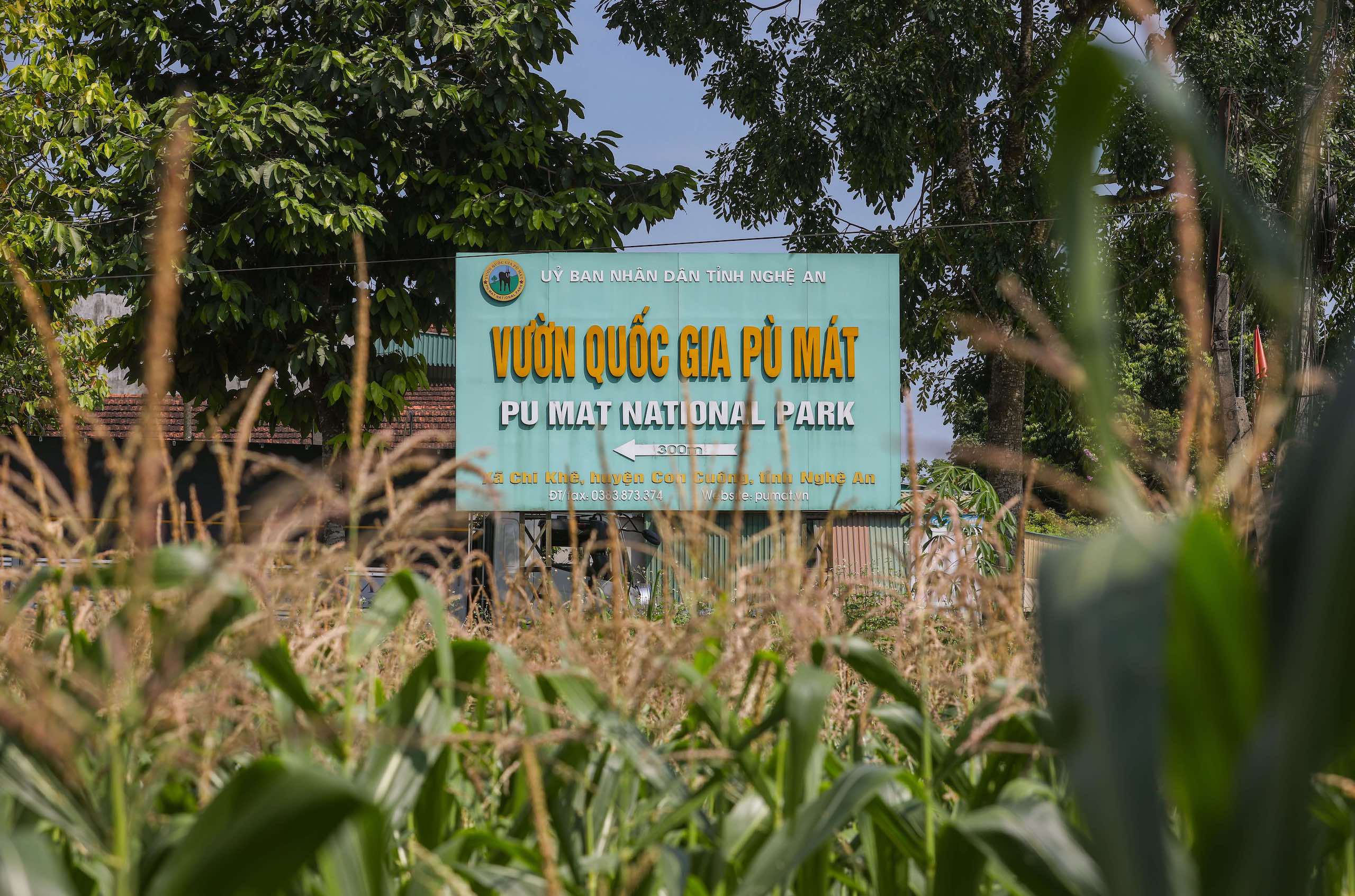 Sign for Pu Mat National Park, crops in foreground