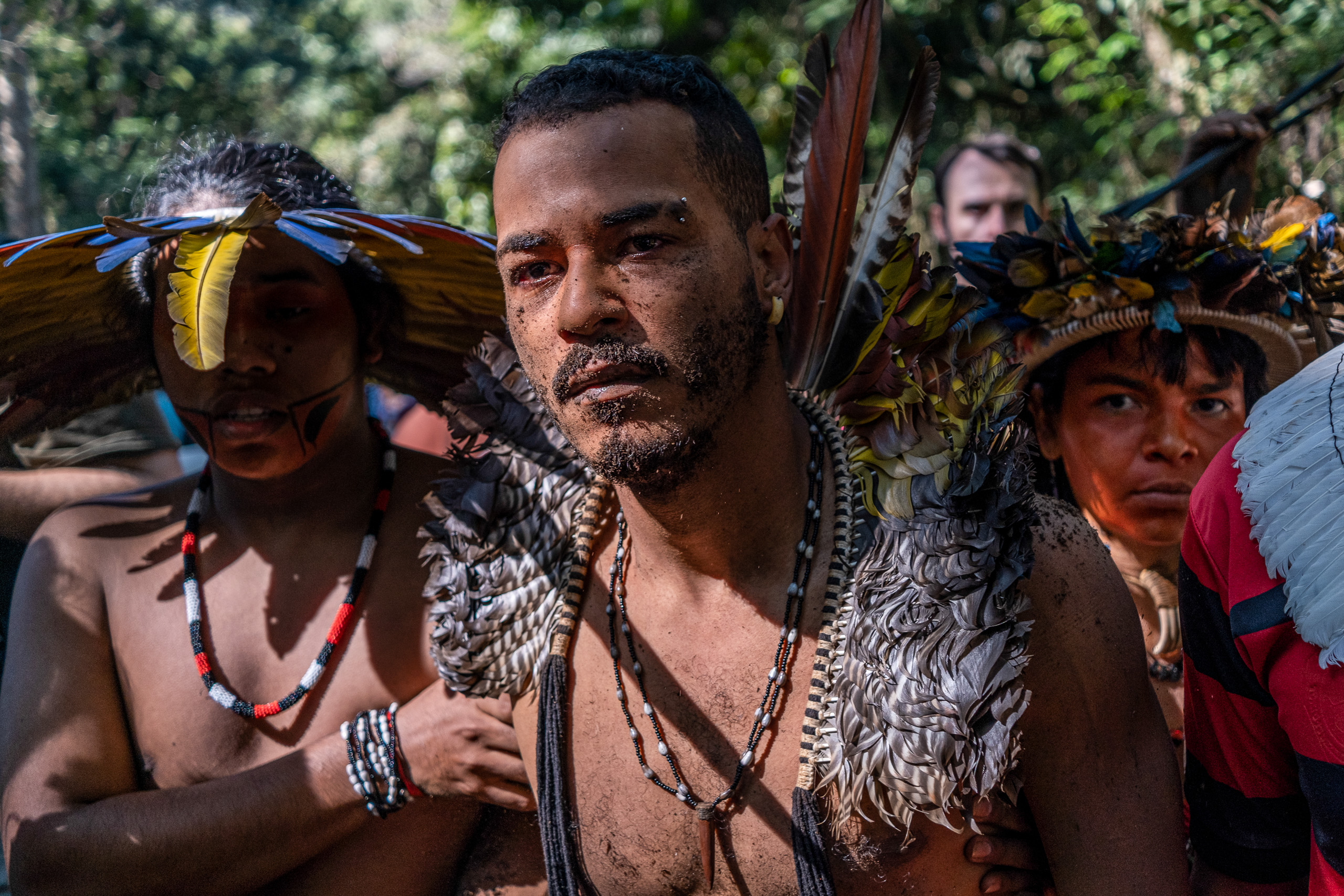 a group of people wearing feathered clothing