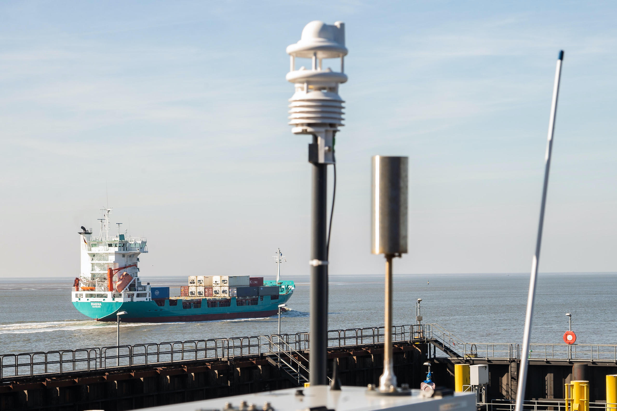 A container ship sailing past the remote measuring station for ship emissions