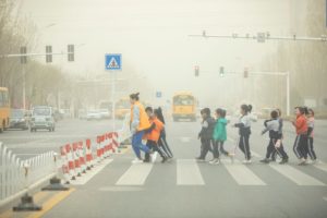 Students cross a road during a sandstorm in Shandong, China
