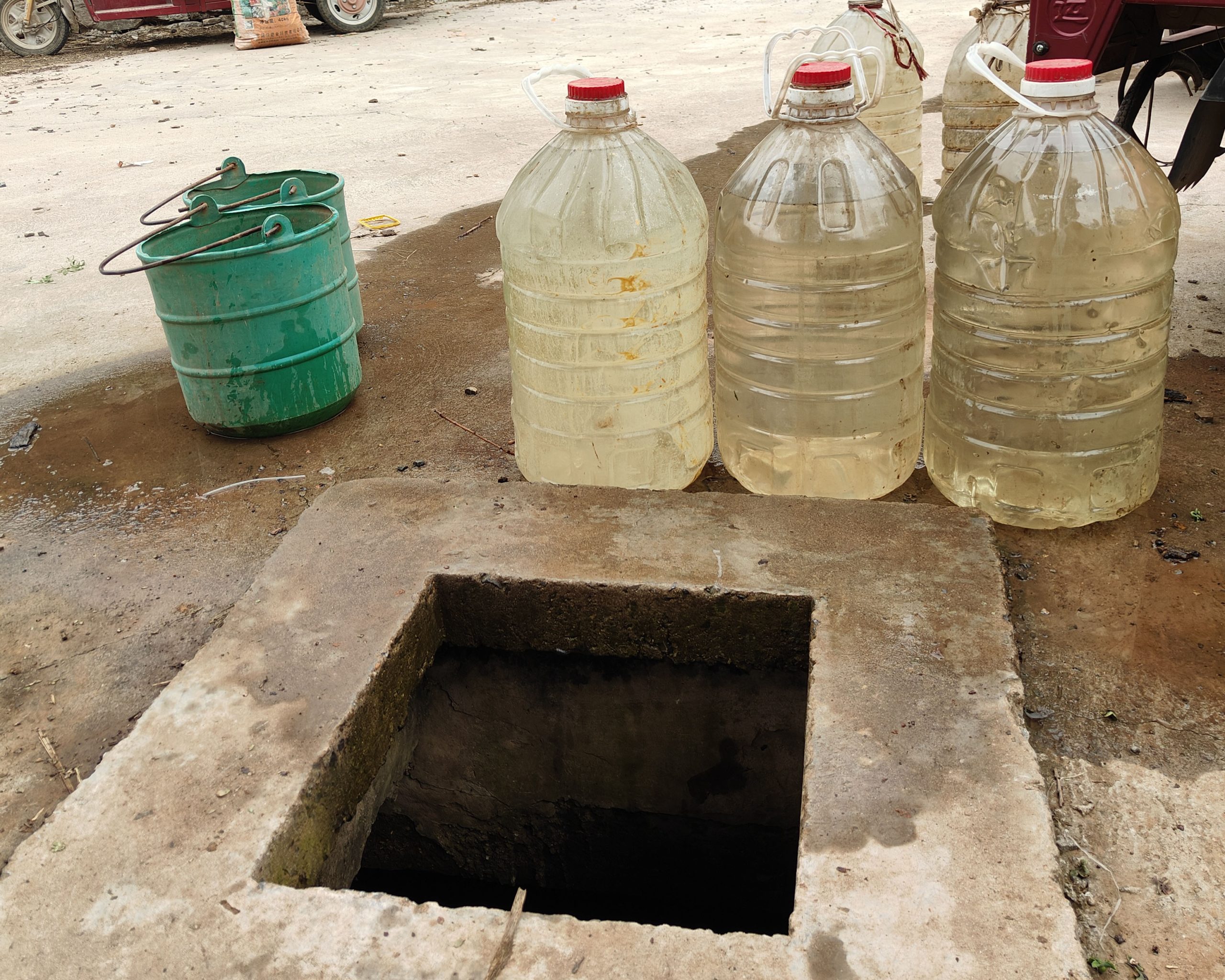 water jugs next to a rainwater collection cistern