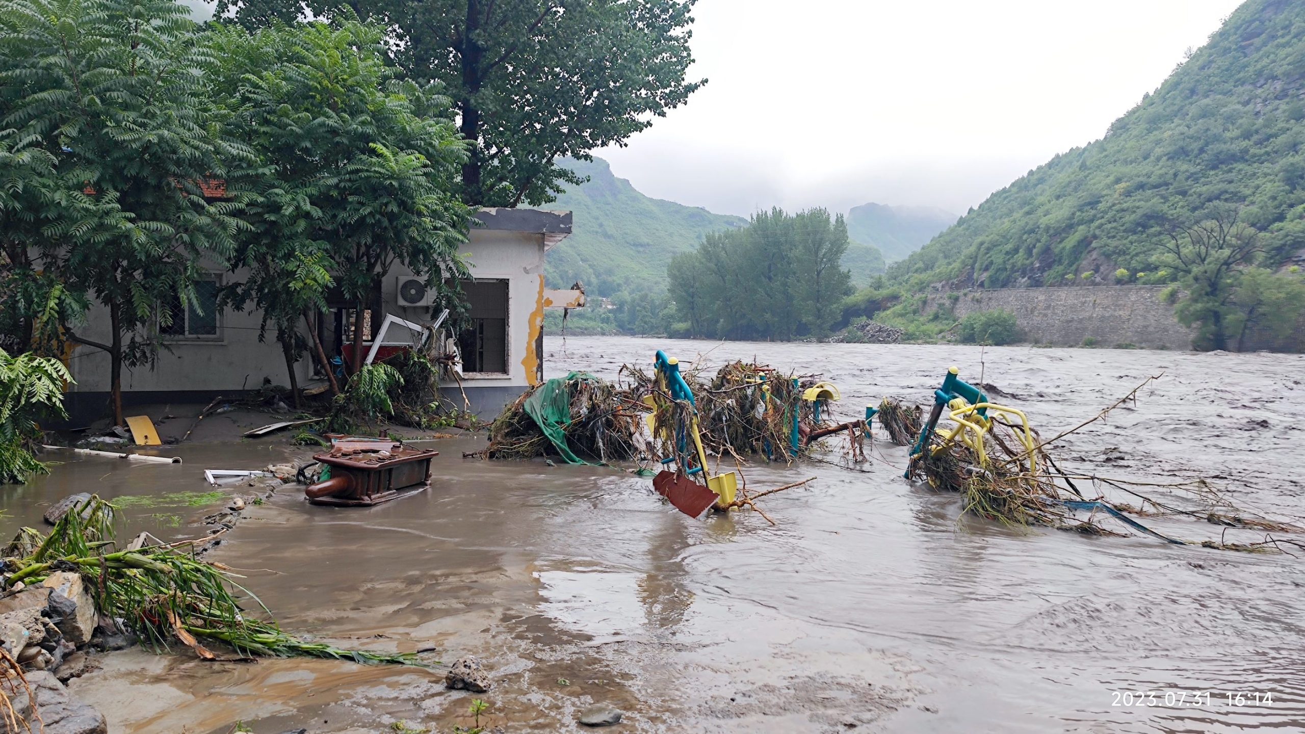 a flooded house with a pile of trash and debris