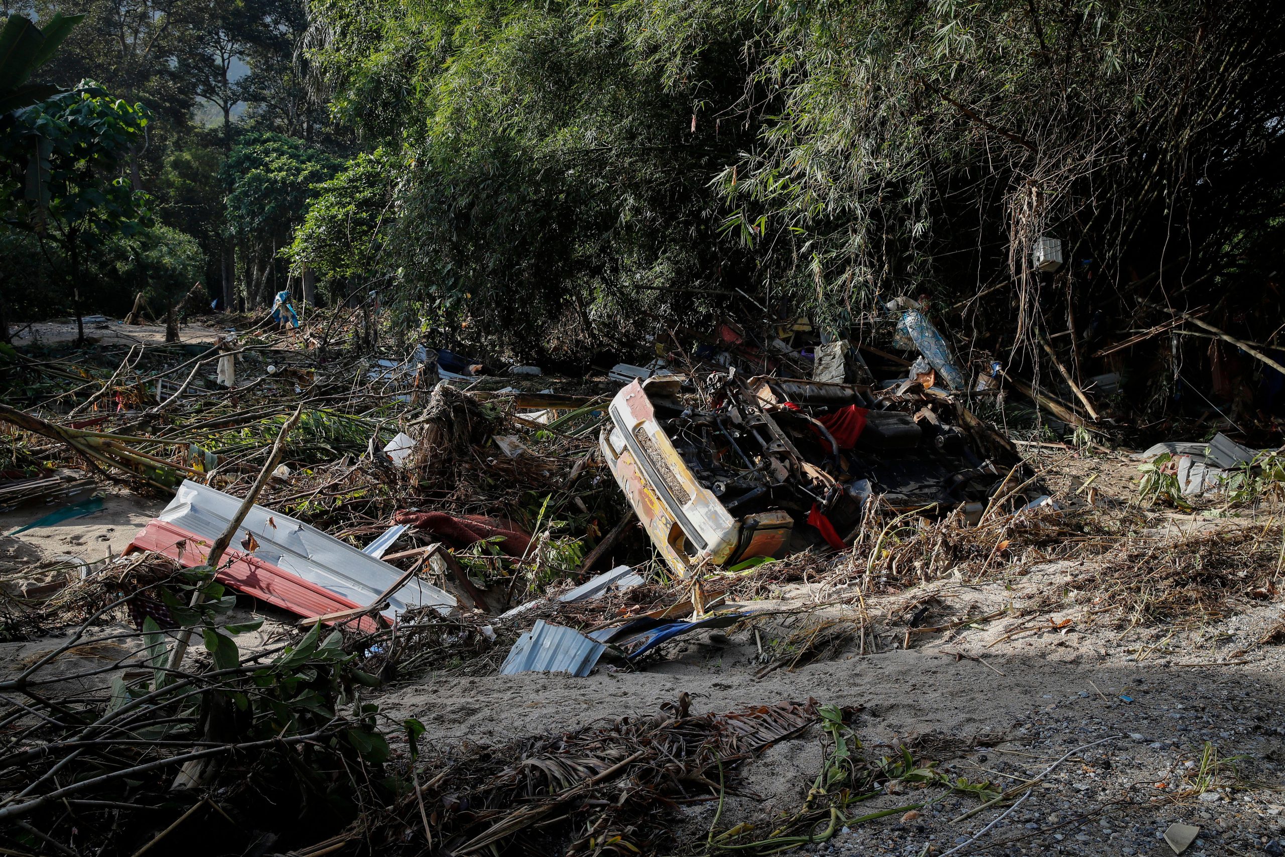upside down damaged car stuck in mud