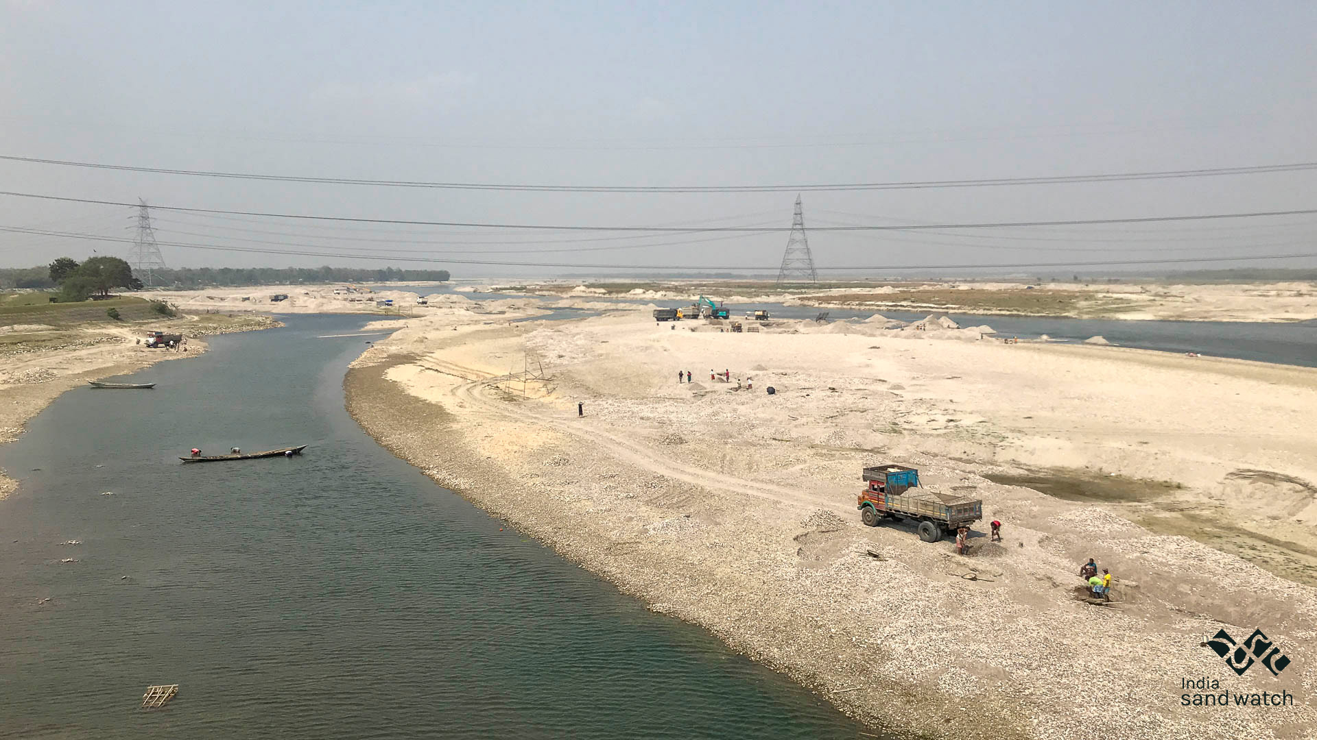 truck loaded with sand on riverbank