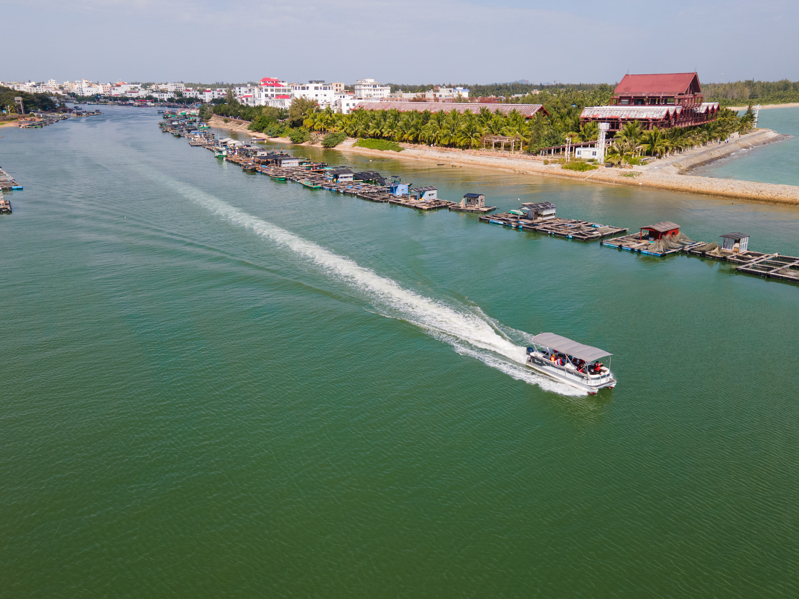 a small boat sailing along a river estuary