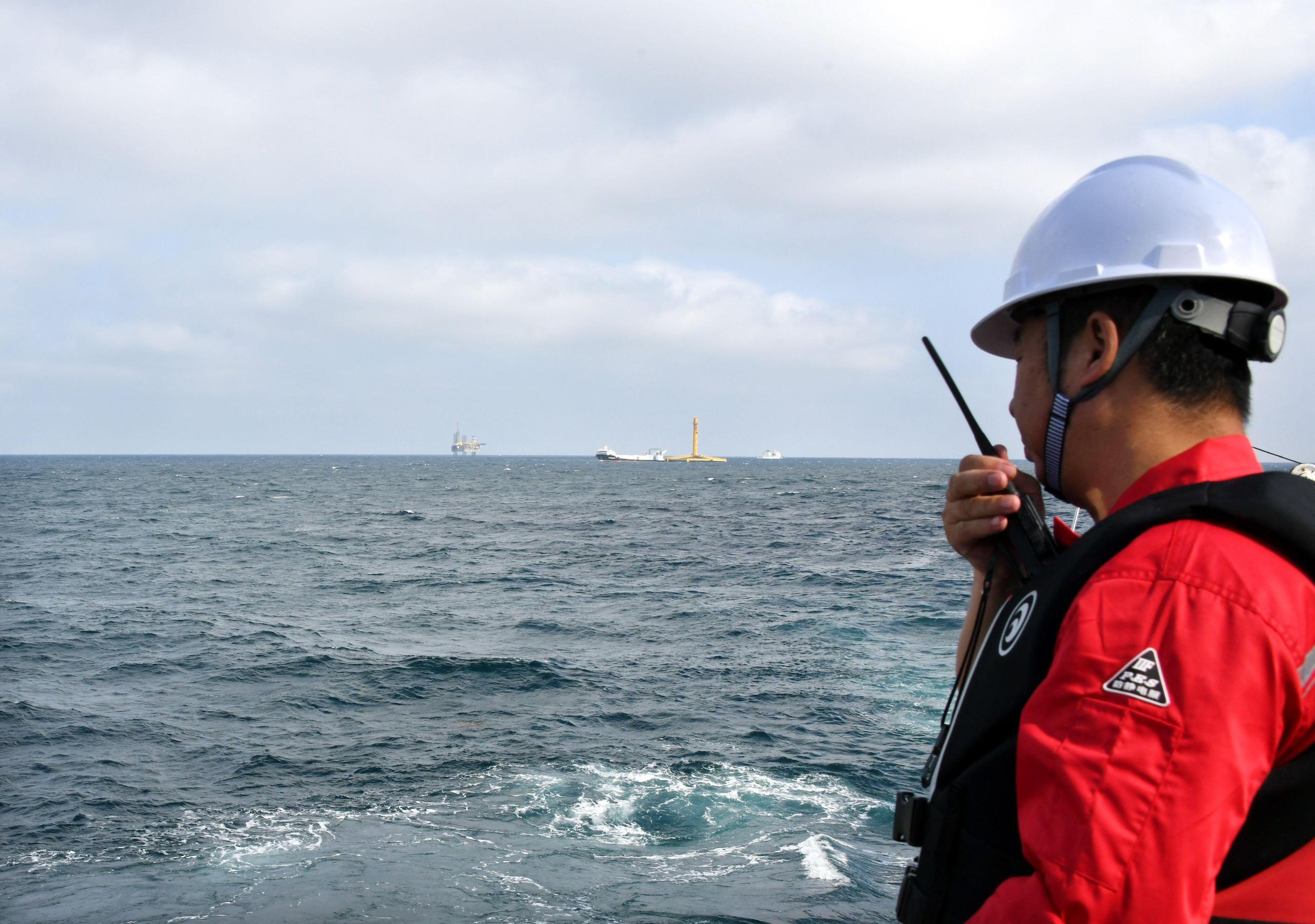 A staff working salmons at a fish farming