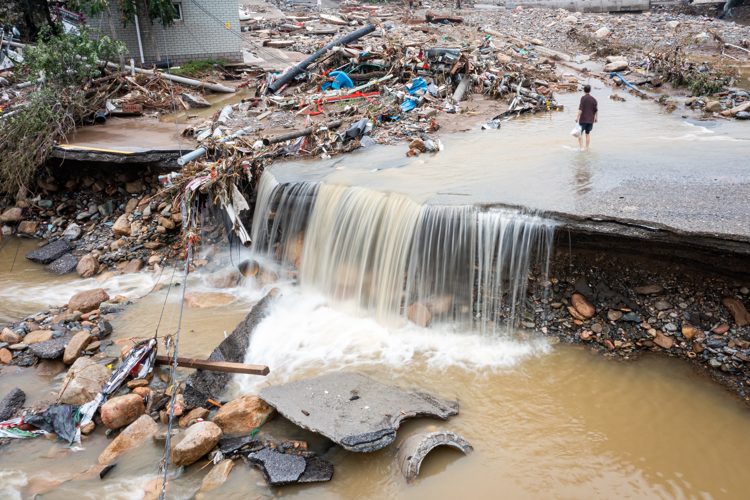 <p>Destroyed roads in Mentougou district, western Beijing. The Chinese capital was hit by four consecutive days of intense rain, as remnants of Typhoon Doksuri battered the country. (Image © <a href="https://gallagher-photo.com">Sean Gallagher)</a></p>