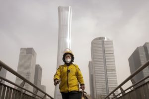 <p>A Beijing resident on a smoggy day in March this year. A recent uptick in ozone pollution threatens China’s progress on air quality, as government officials look to boost the economy by green-lighting coal plants and steel factories. (Image: BJ Warnick / Alamy)</p>