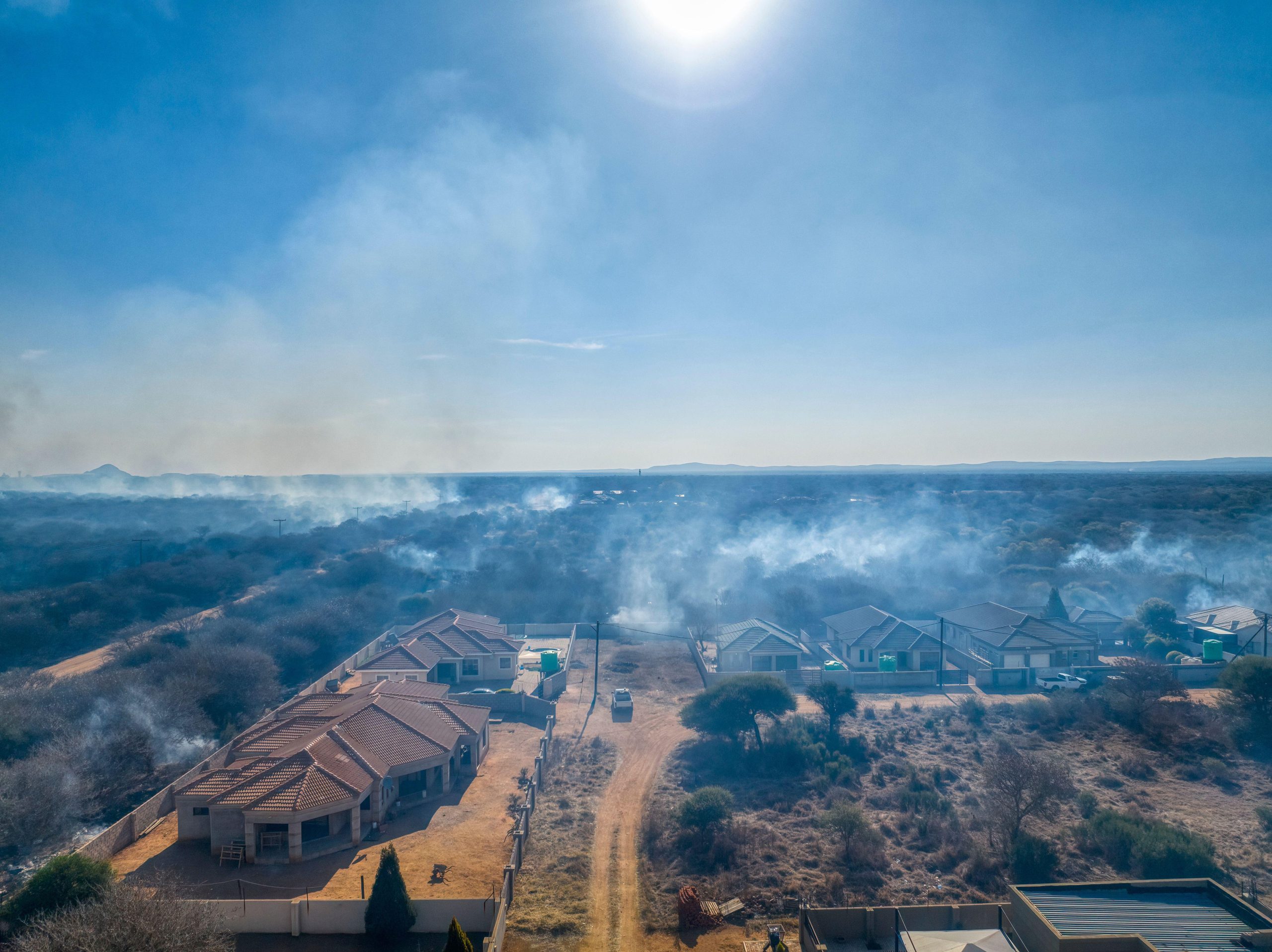 smoke over town surrounded by bush fire