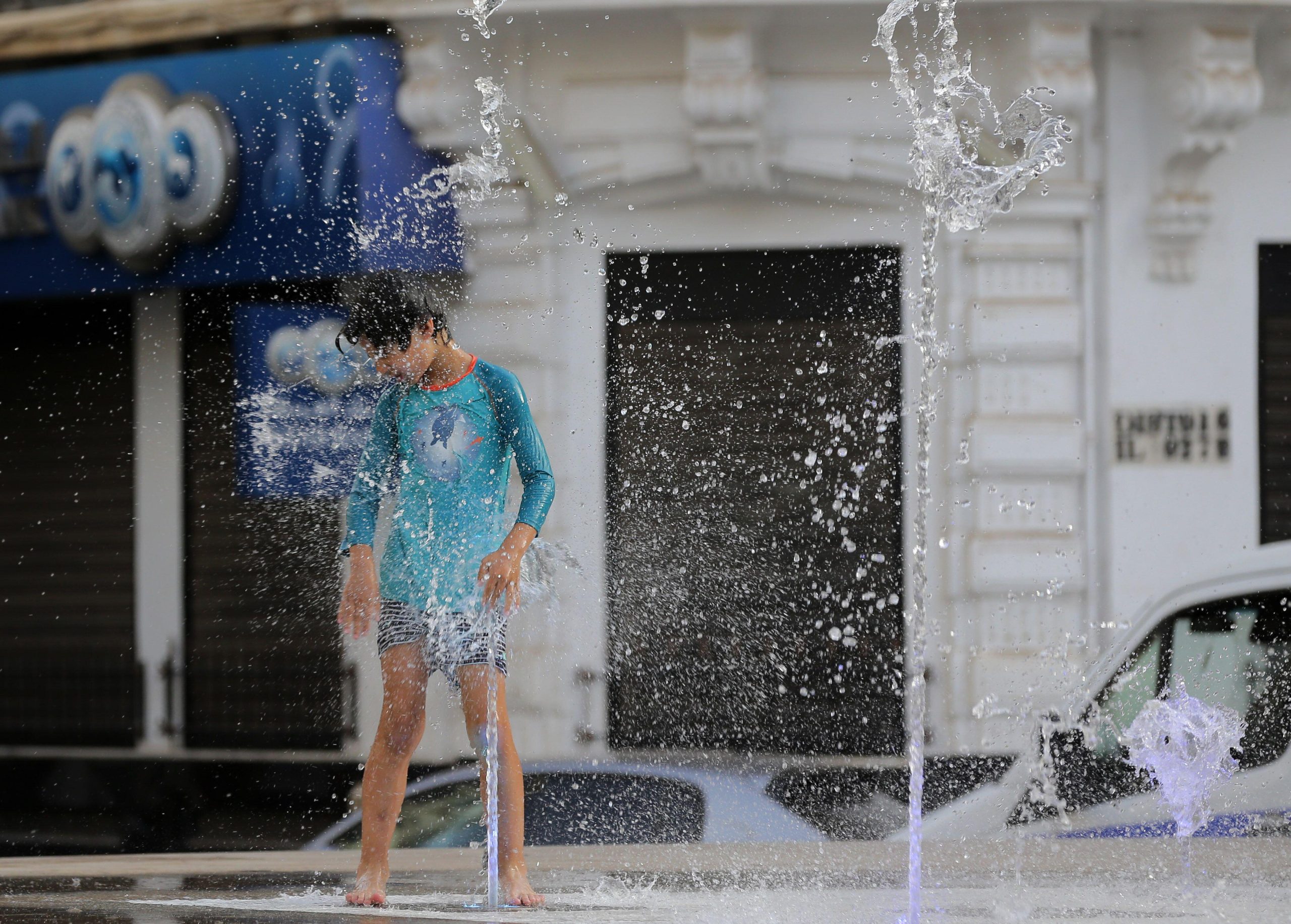 <p>A boy cools off during a heatwave in downtown Algiers, Algeria, July 2023 (Image: Alamy)</p>