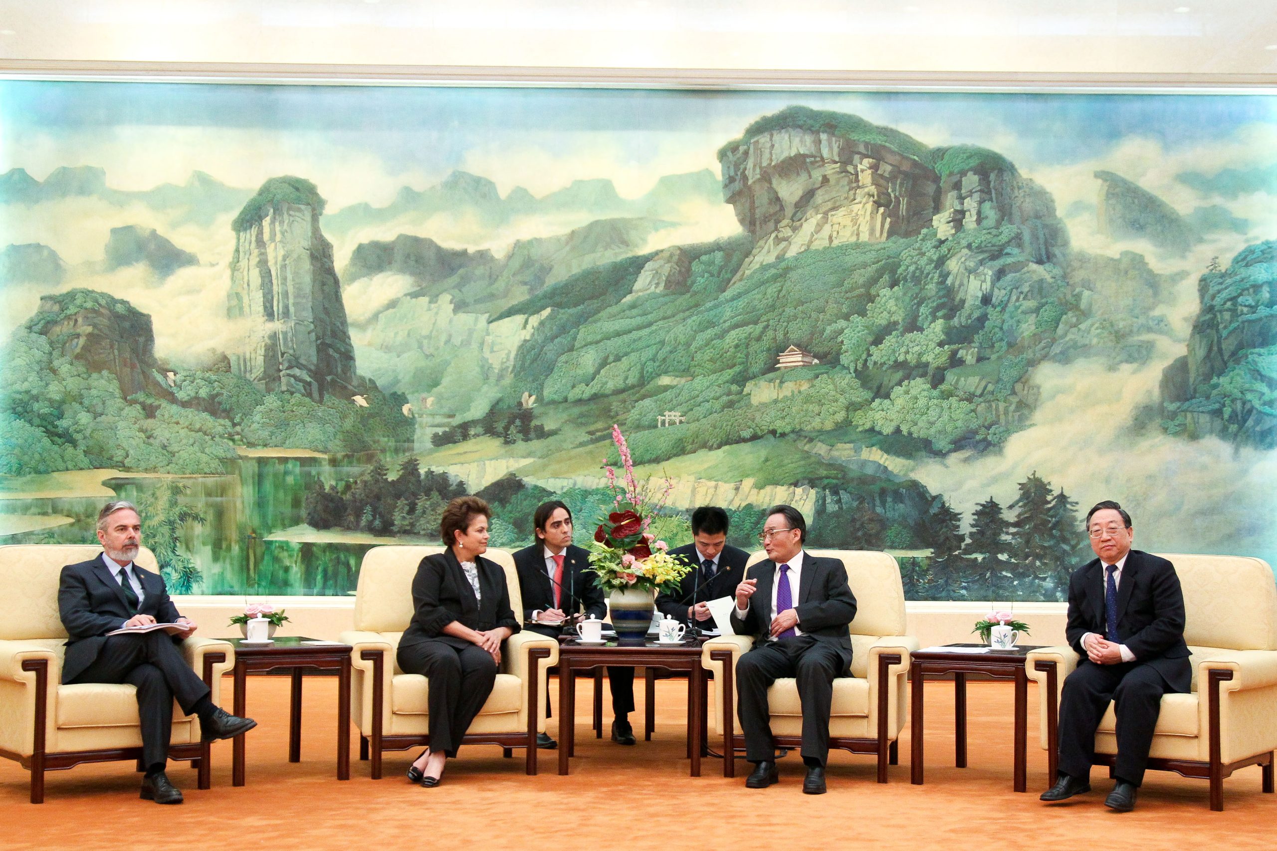 group of men in suits sitting on armchairs