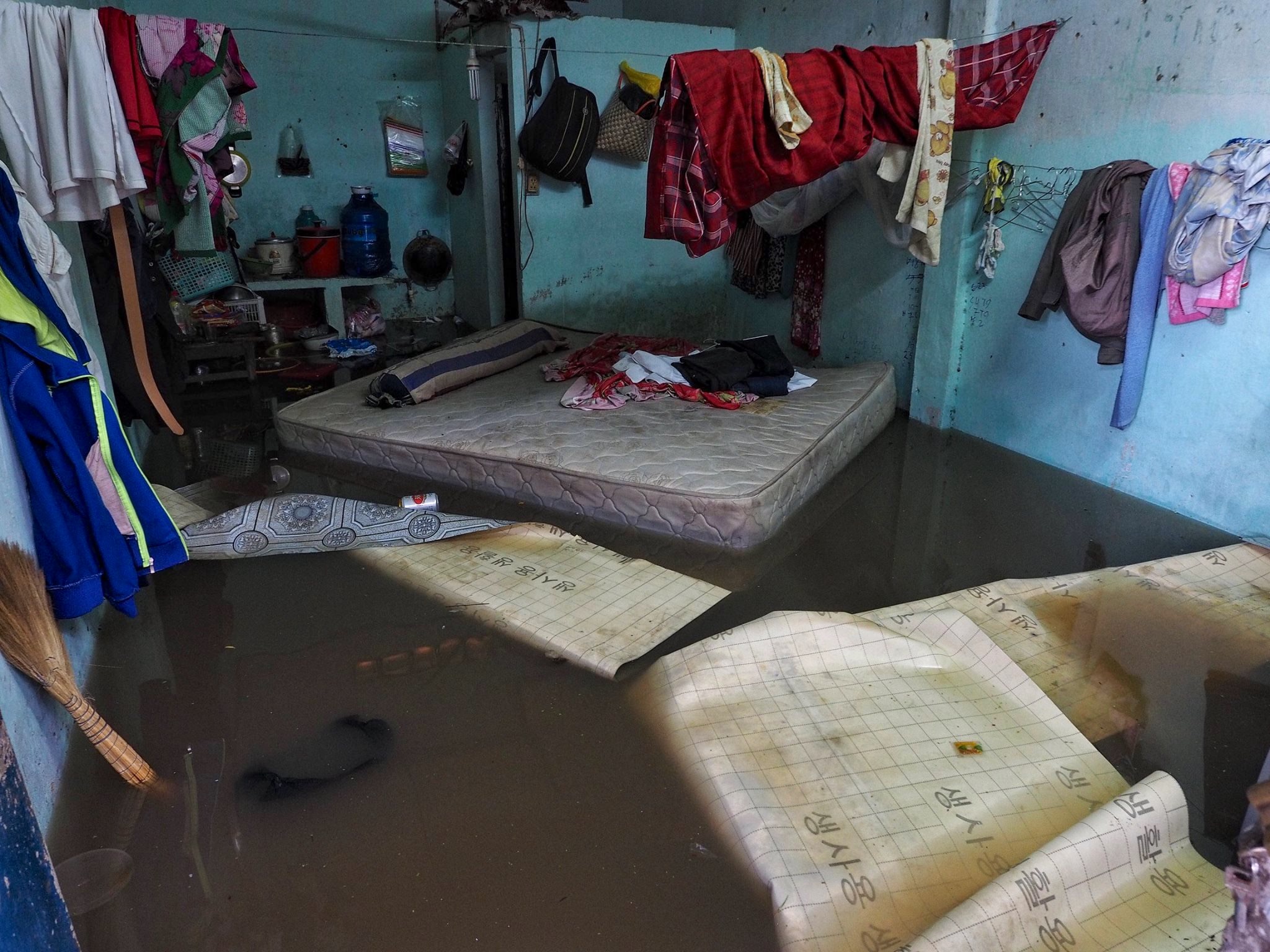 A flooded room full of damaged furniture