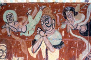 Colourful painting of buddhist figures on a wall