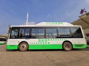 Green and white hydrogen-powered bus with Chinese characters on the side