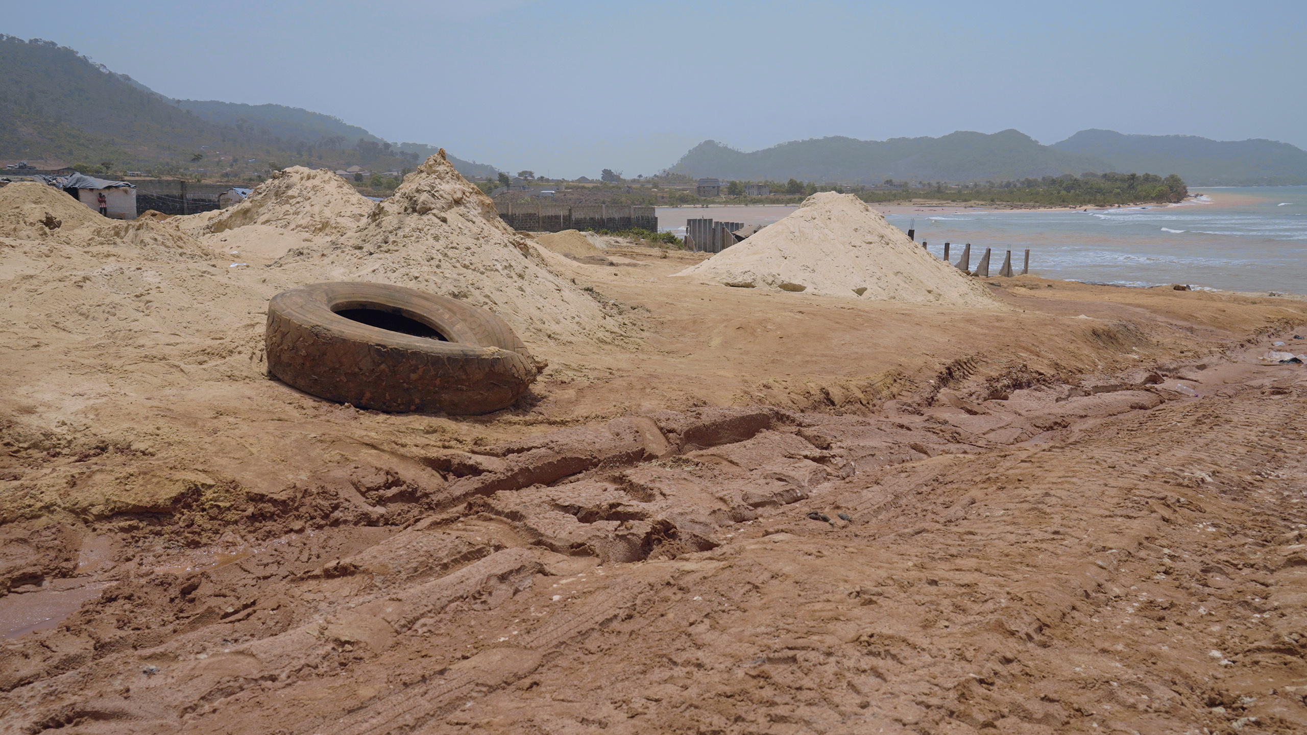 deflated tyre on sandy beach