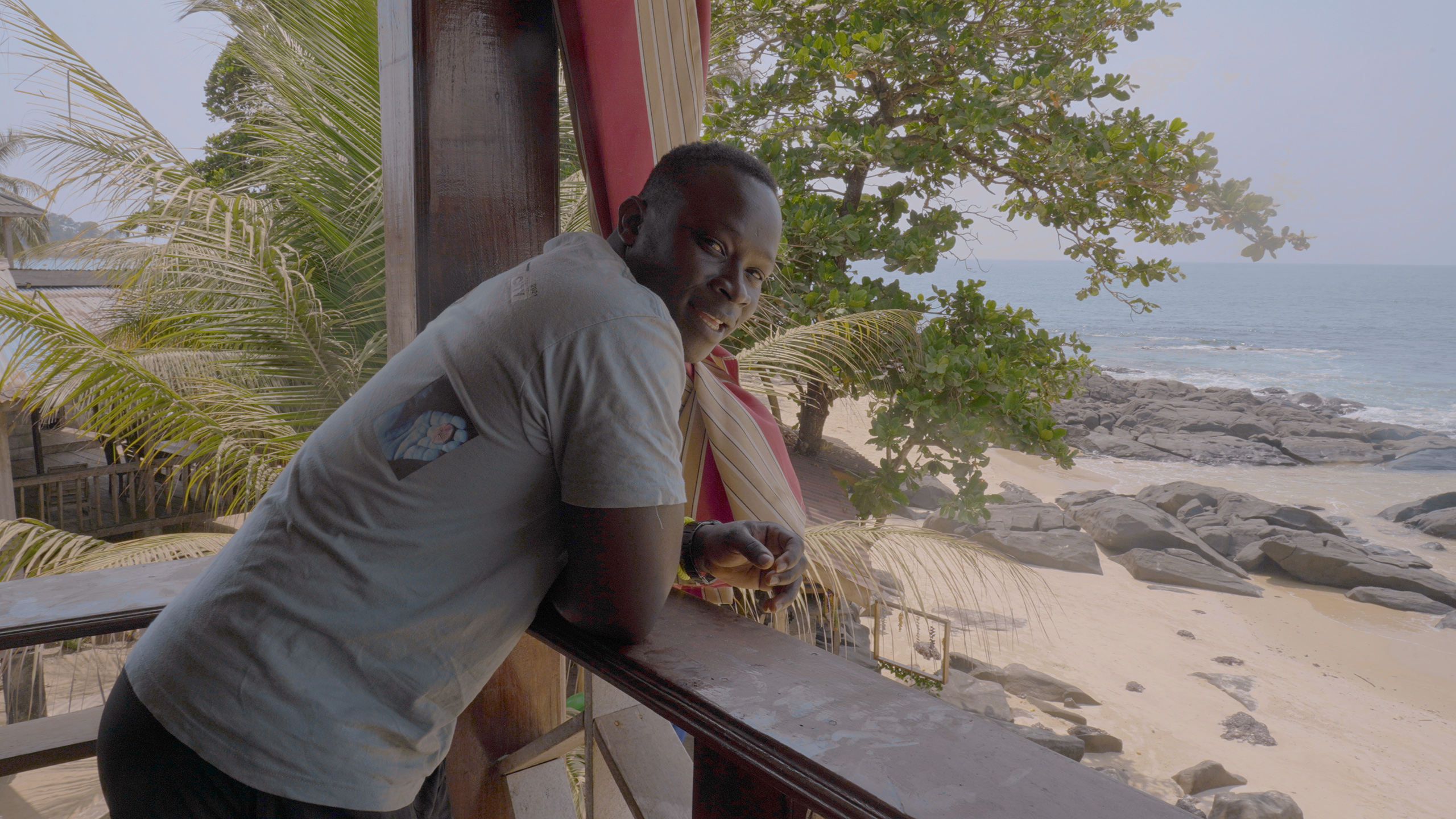 man leaning over balcony