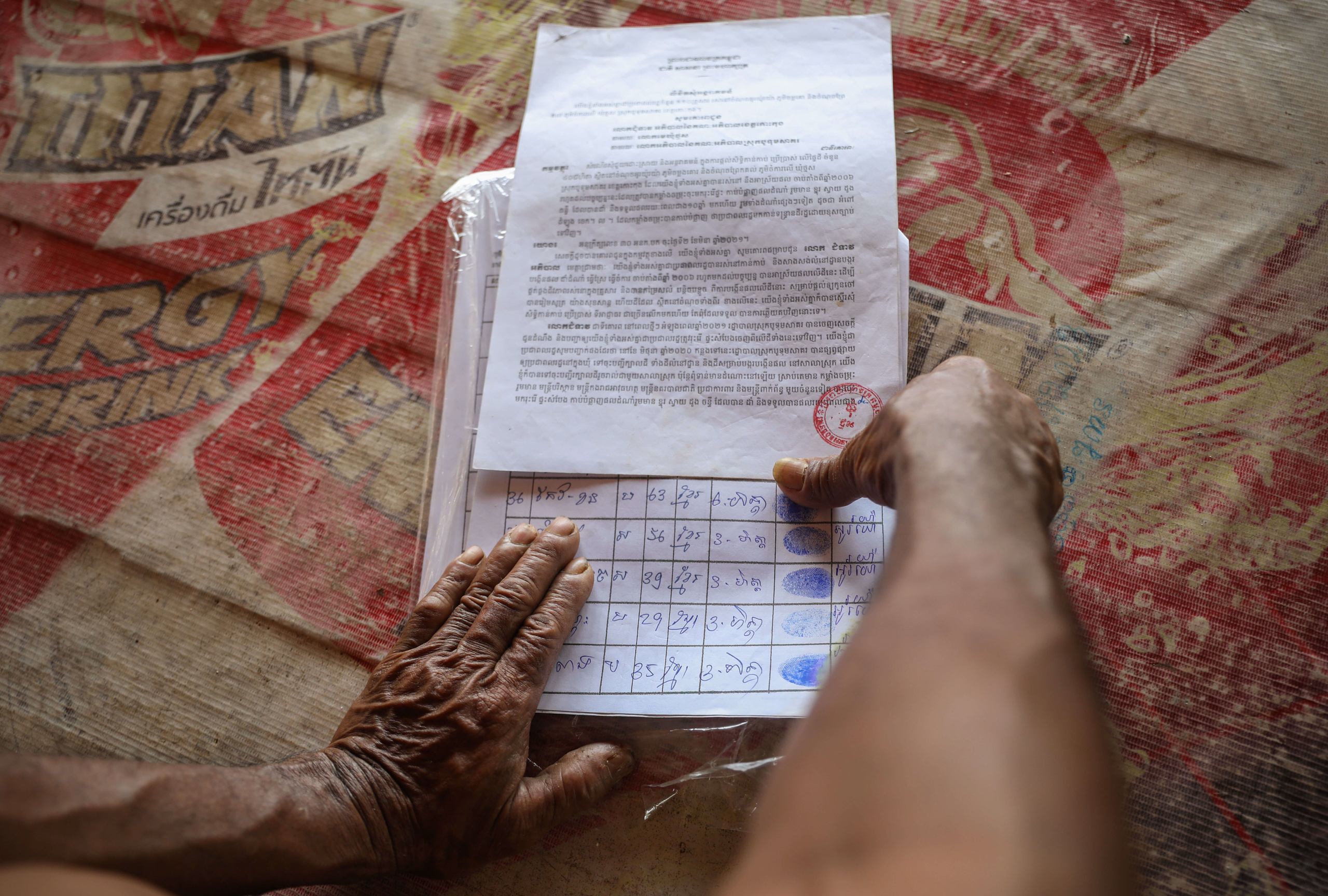 Someone presses a thumb against a piece of paper 