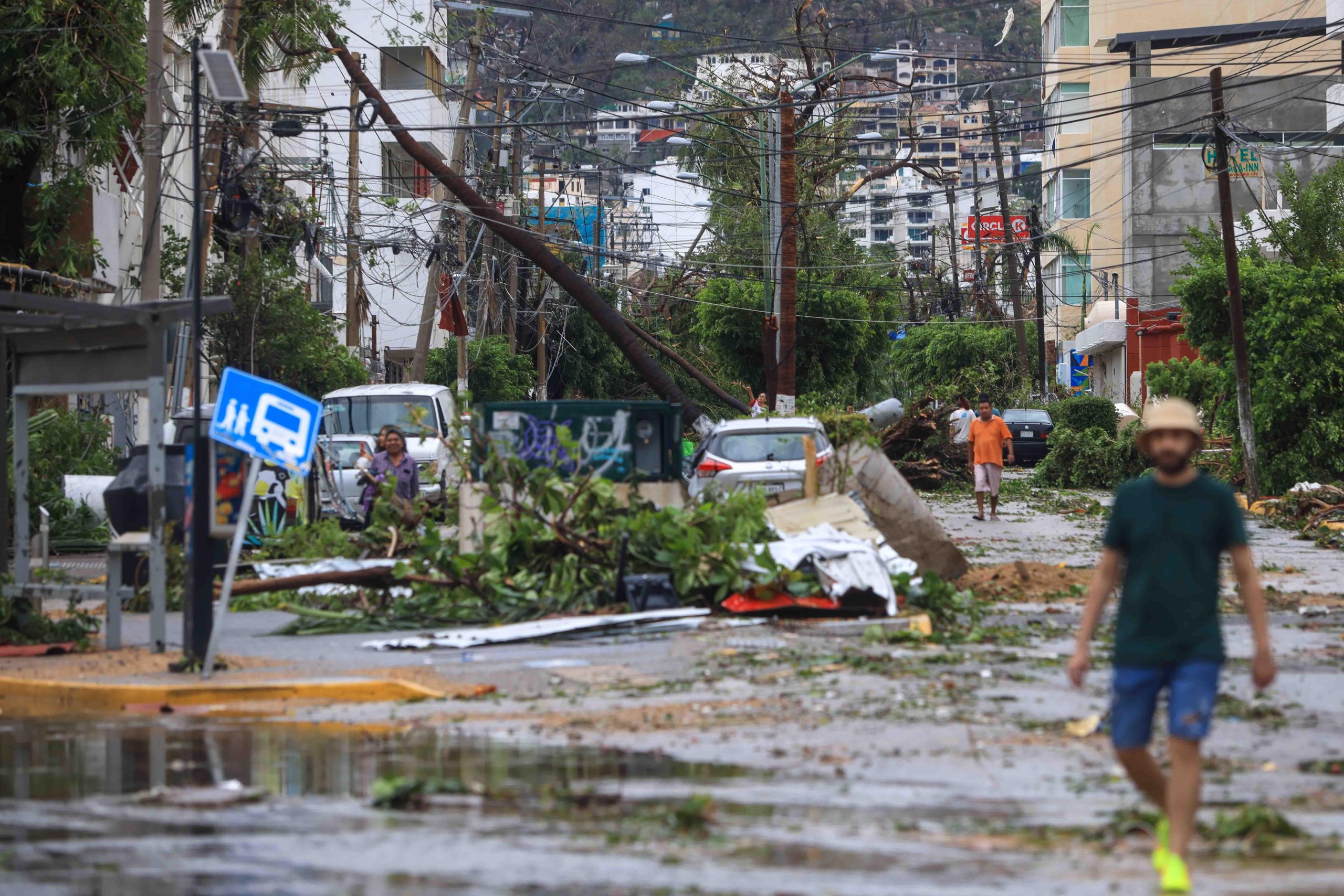 <p>People walk through a tourist area of Acapulco, Mexico, after Hurricane Otis devastated the city on 25 October (Image: Luis Gutierrez / Alamy)</p>