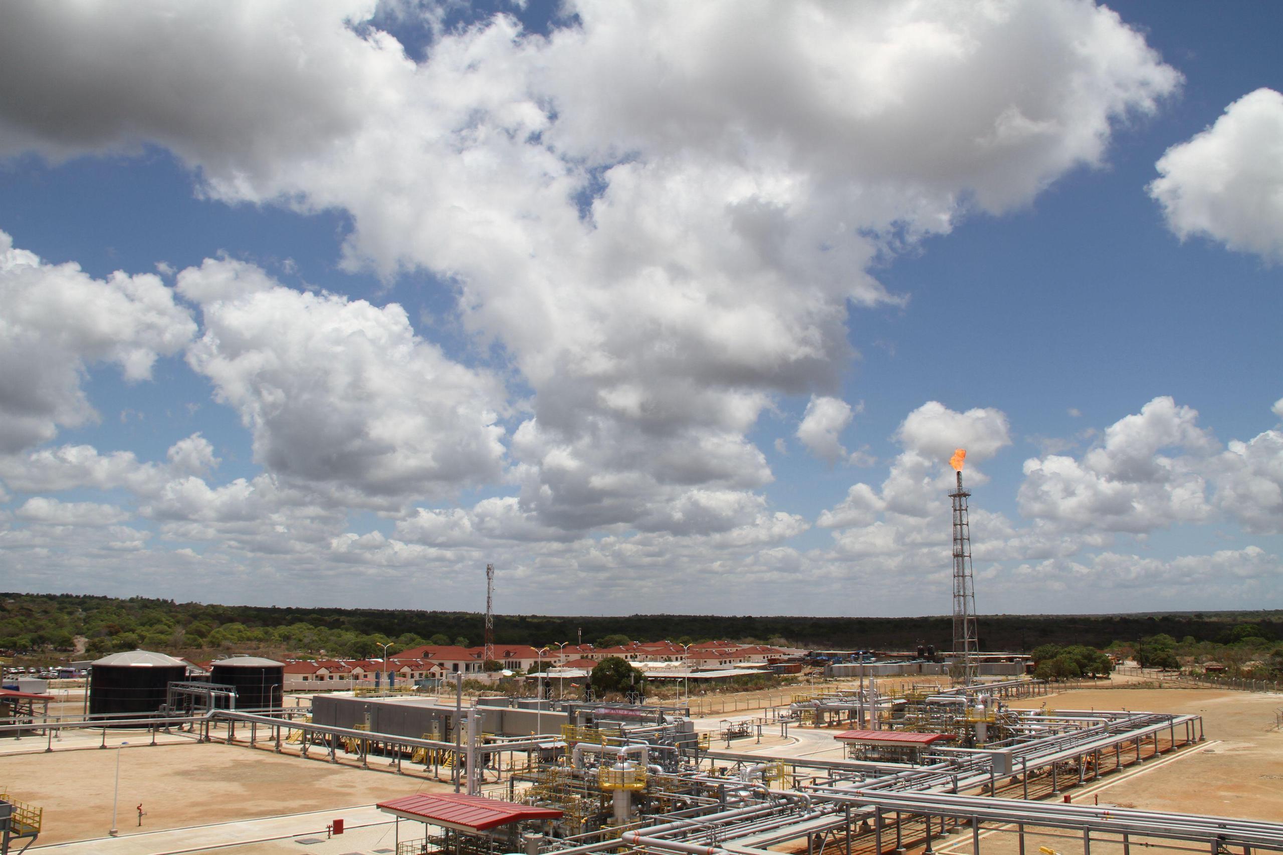 Cloudy sky above gas extraction industrial area