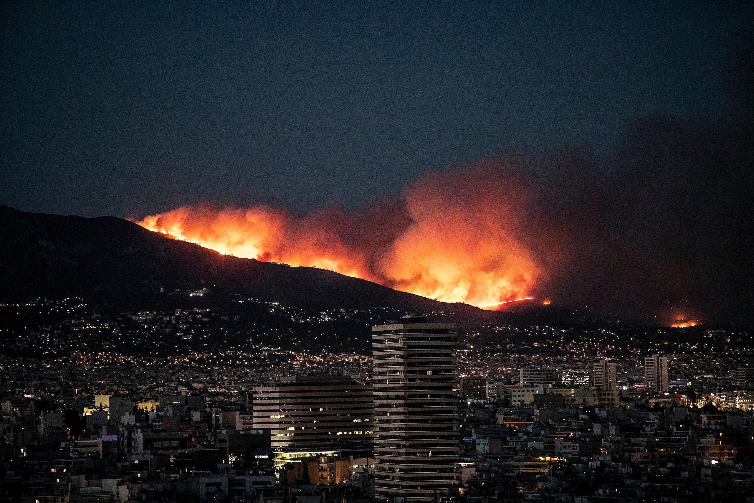 <p>A massive wildfire atop a mountain in the northern suburbs of Athens, Greece (Image: Panagiotis Moschandreou / Alamy)</p>
