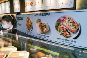 <p>A menu offering plant-based meat meals at a Starbucks cafe in Shanghai (Image: Wang Gang / AP via Alamy)</p>
