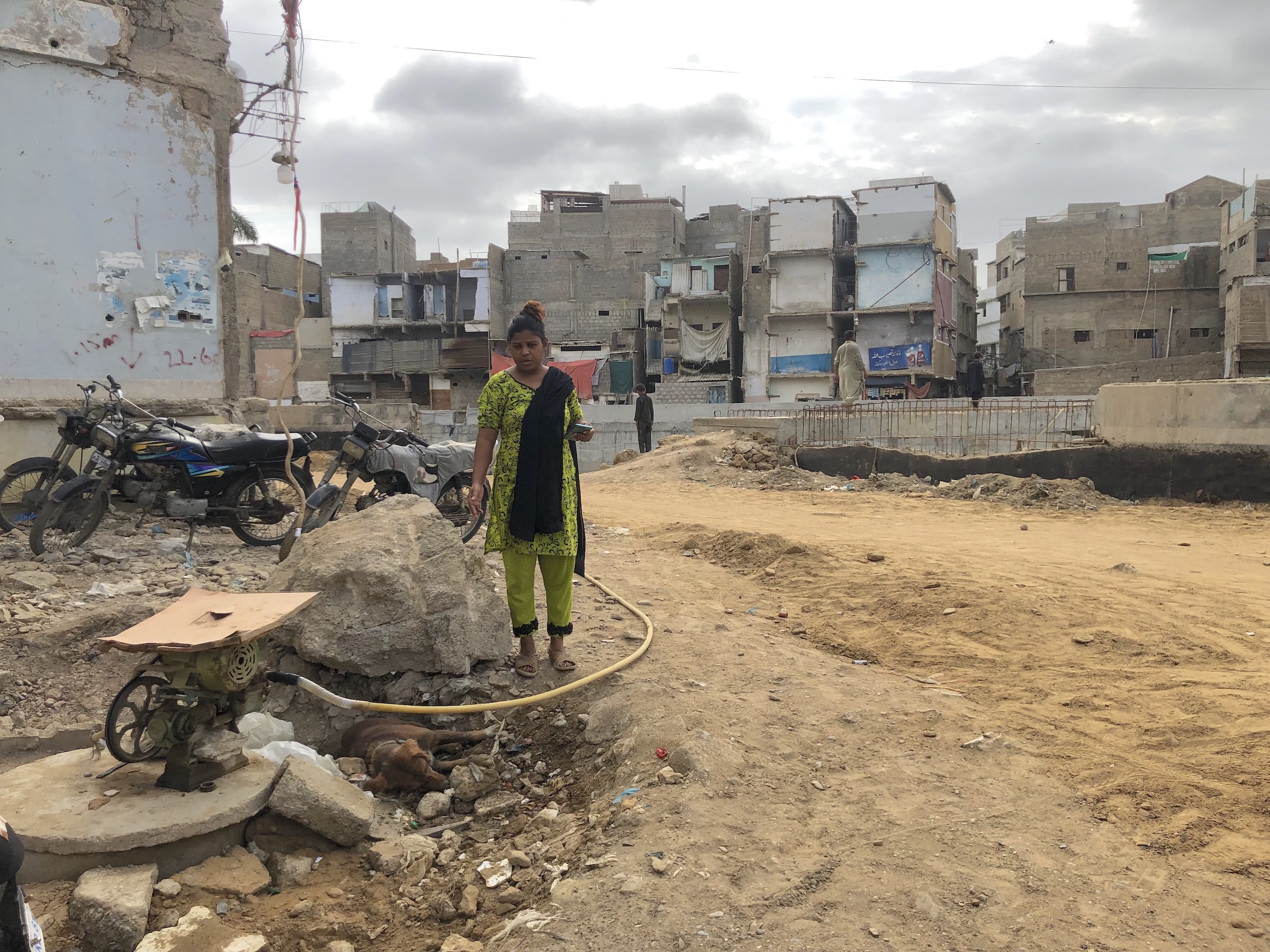 Woman standing in an informal housing neighbourhood