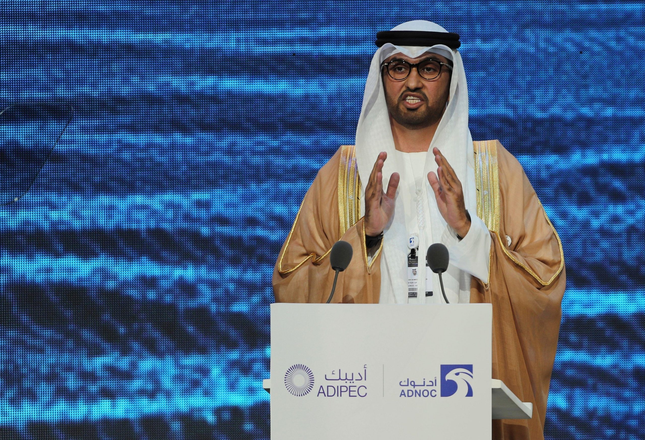 Sultán Ahmed al Jaber hablando detrás de un atril