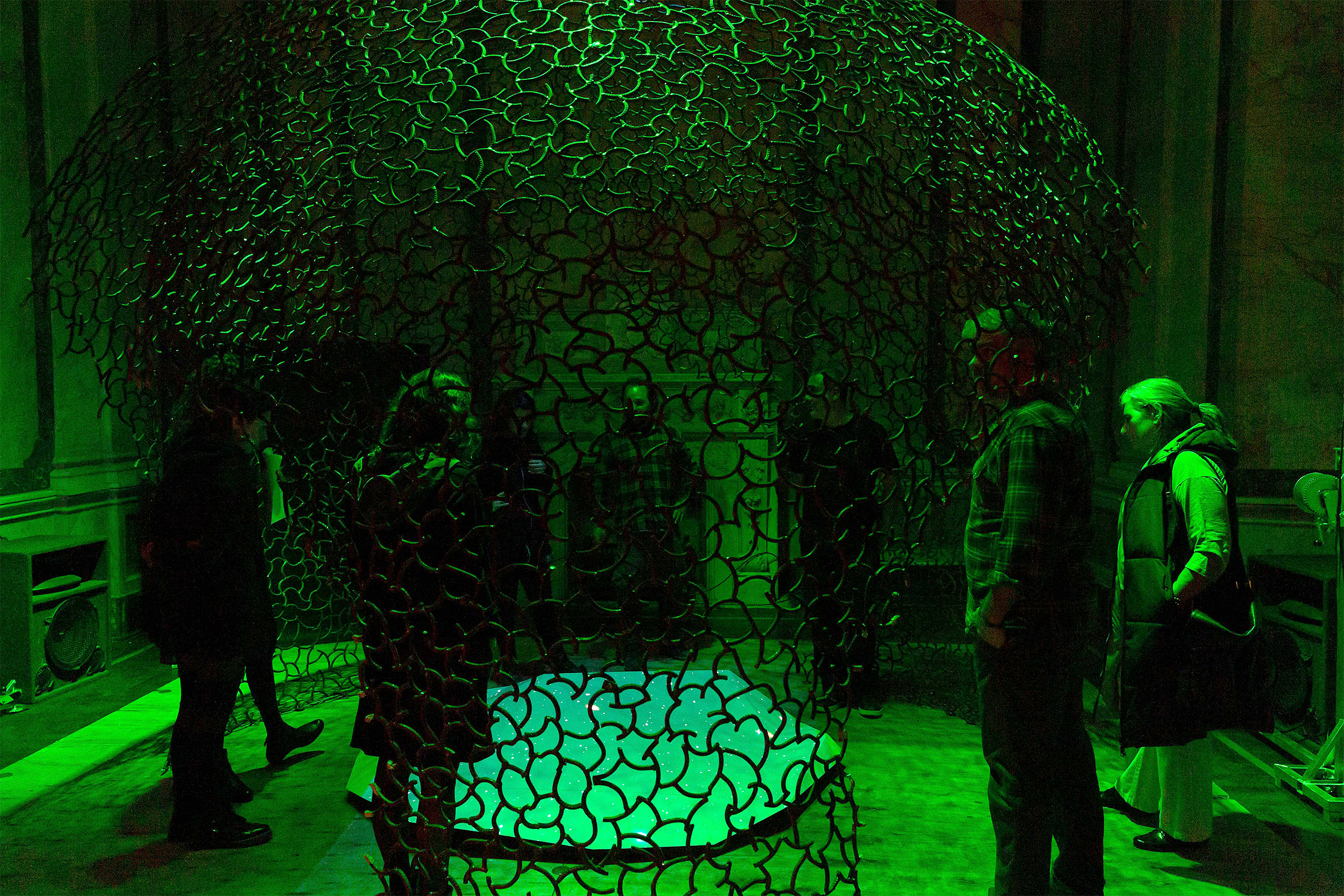 People looking at a piece of metal artwork