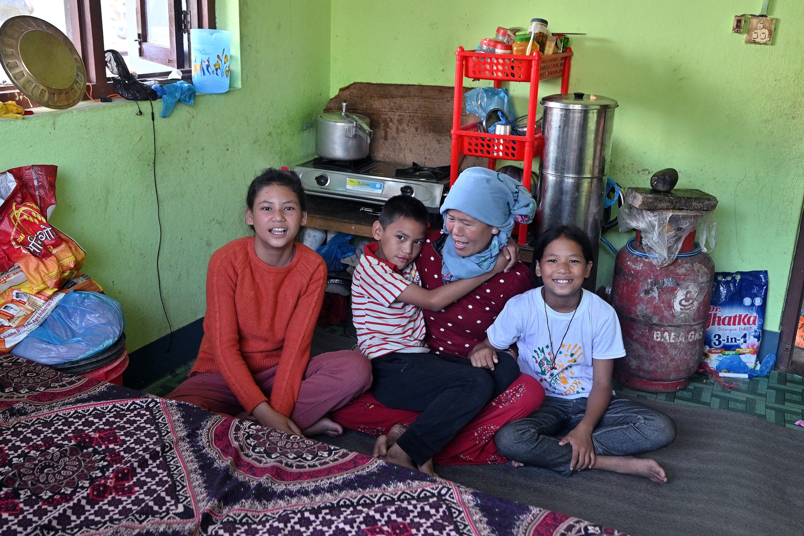 a family sitting on the floor in their home