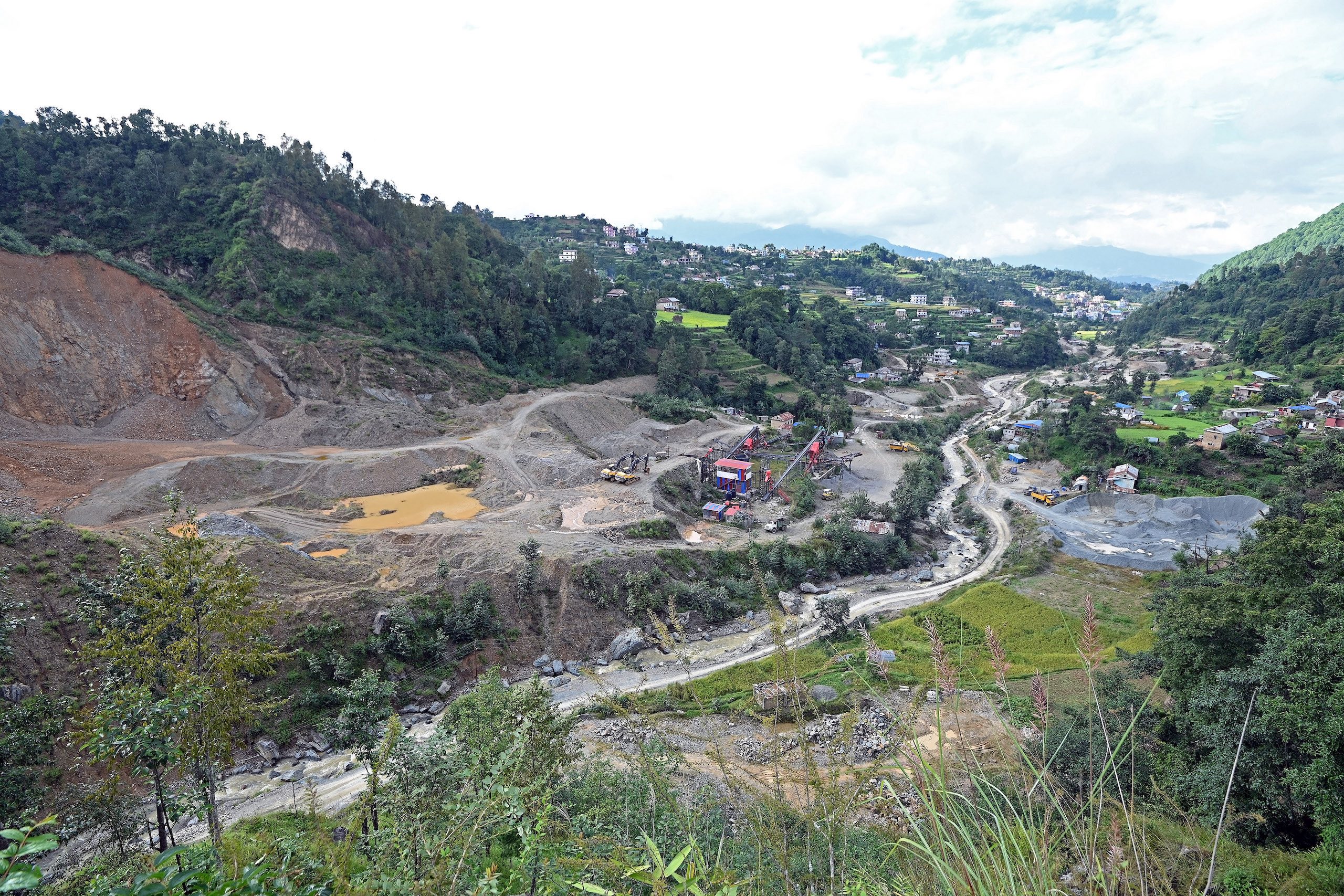 a mountain landscape with a road and trees